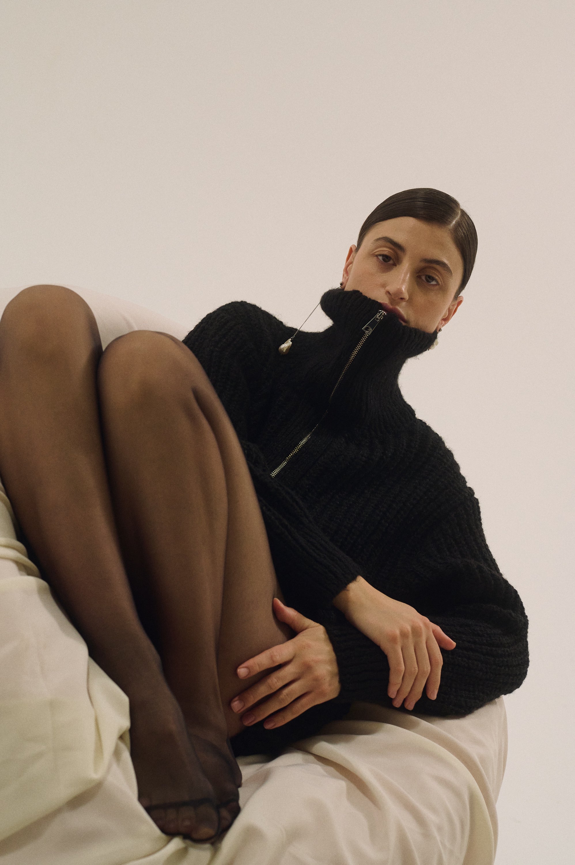 Model wearing asymmetrical baroque pearl drop earrings