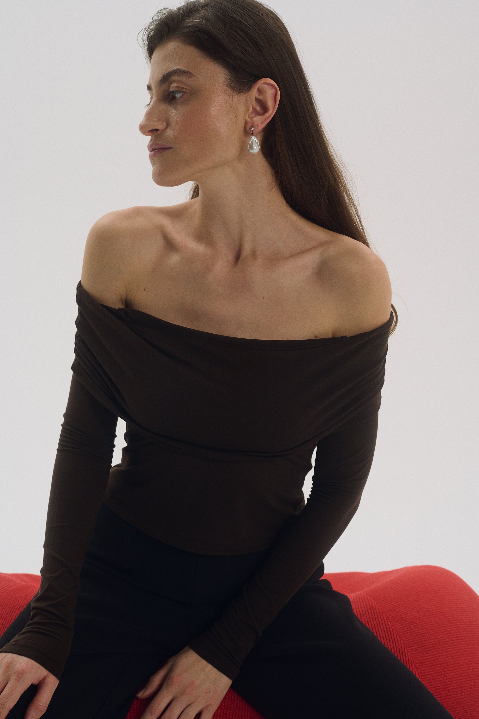 Elegant woman styling white baroque pearl drop earrings