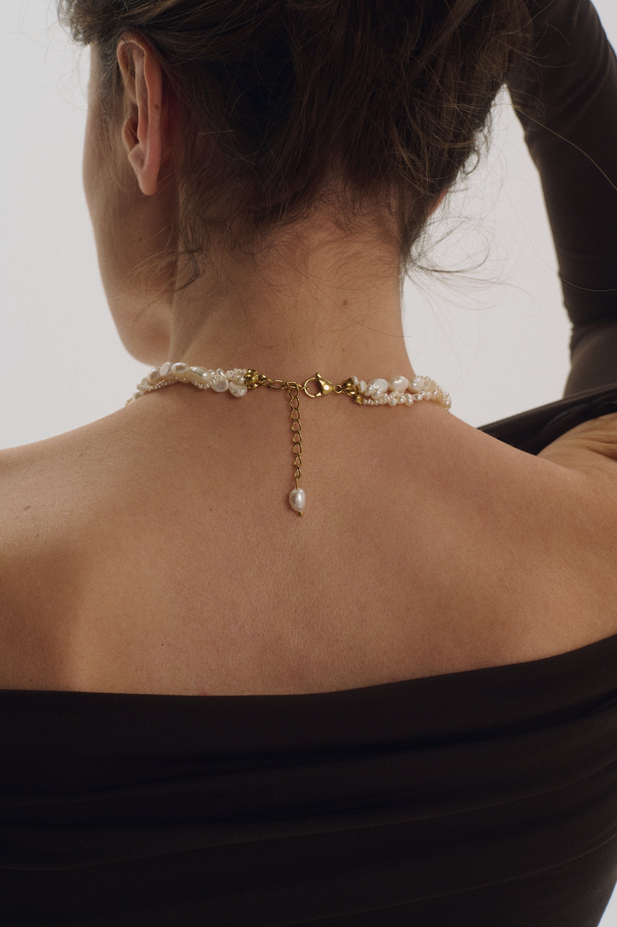 Back view showing gold clasp of braided pearl choker