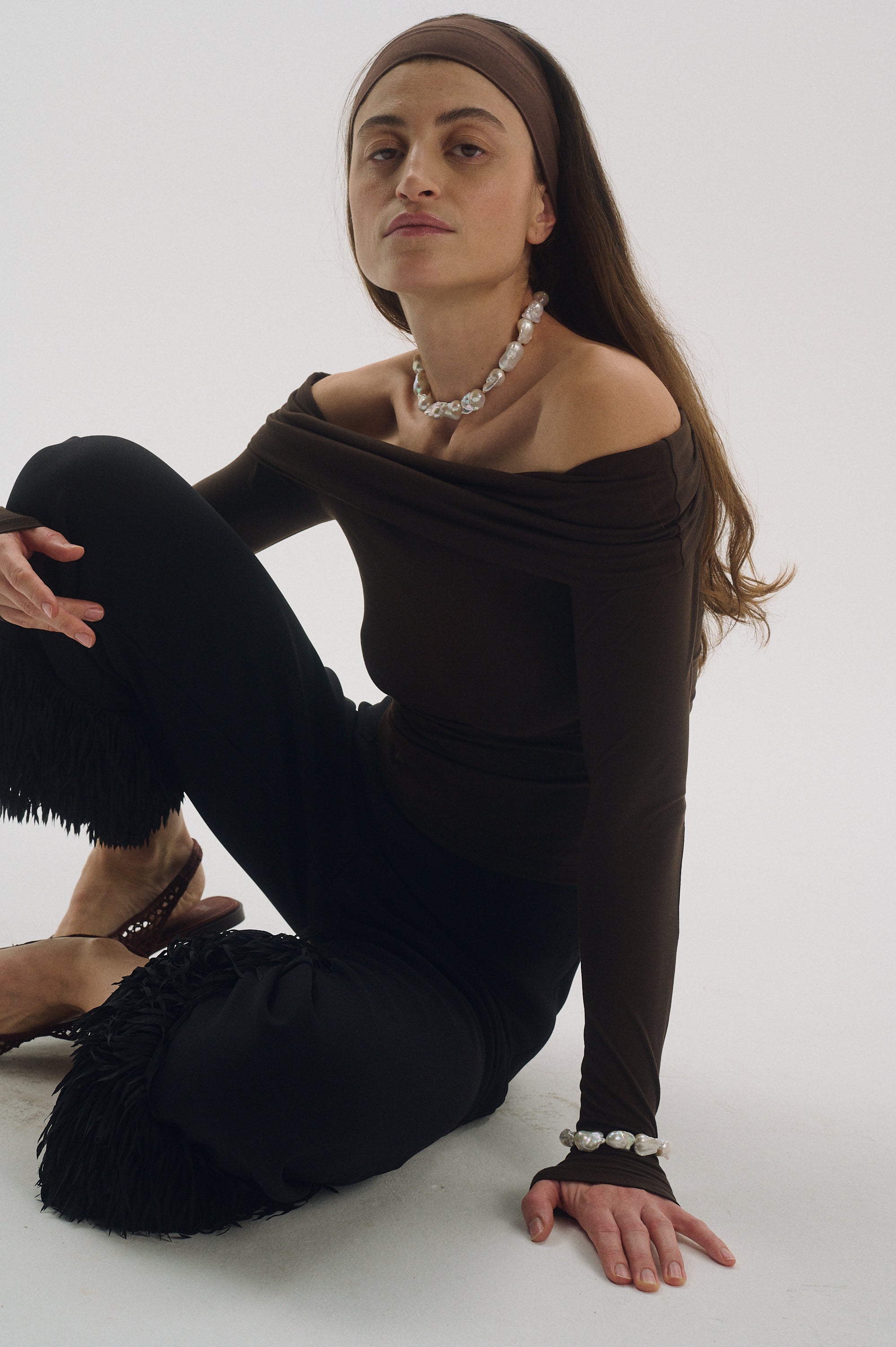 Woman wearing chunky baroque pearl necklace, genuine freshwater pearls with unique organic shapes.