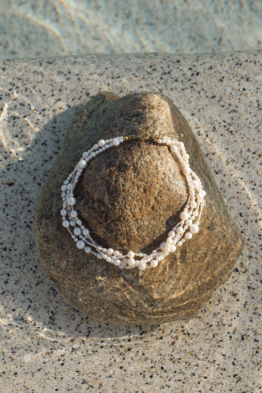 multi-strand pearl necklace photographed in natural light