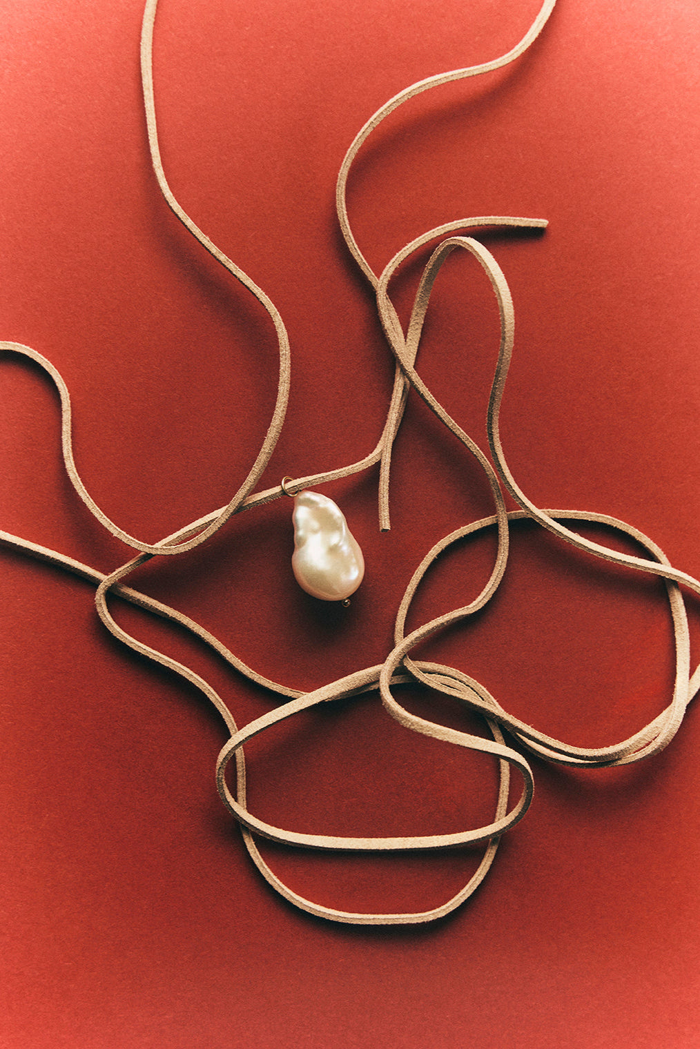 Pearl necklace on a red background