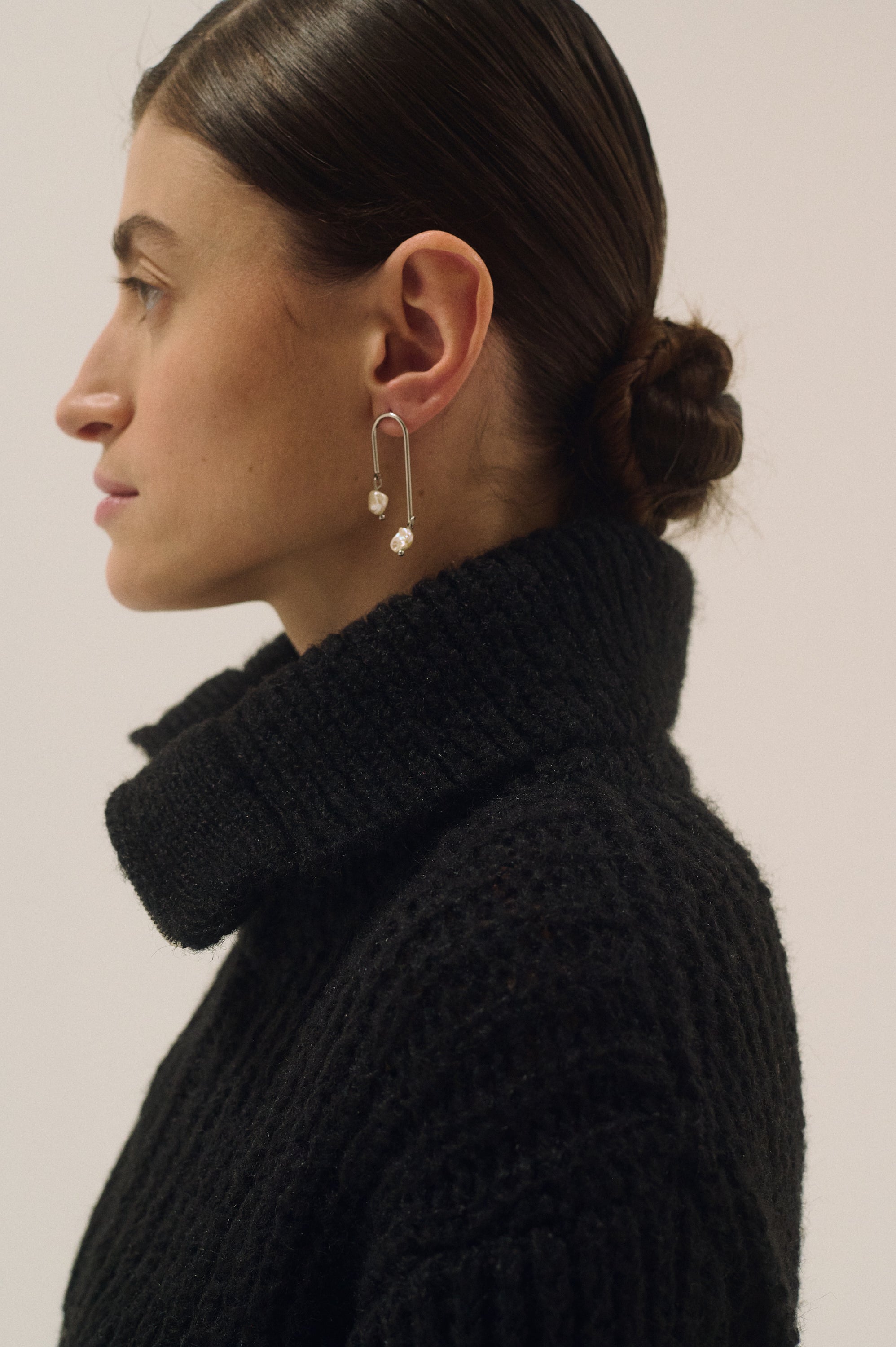 Side profile view of silver Keshi pearl drop earrings