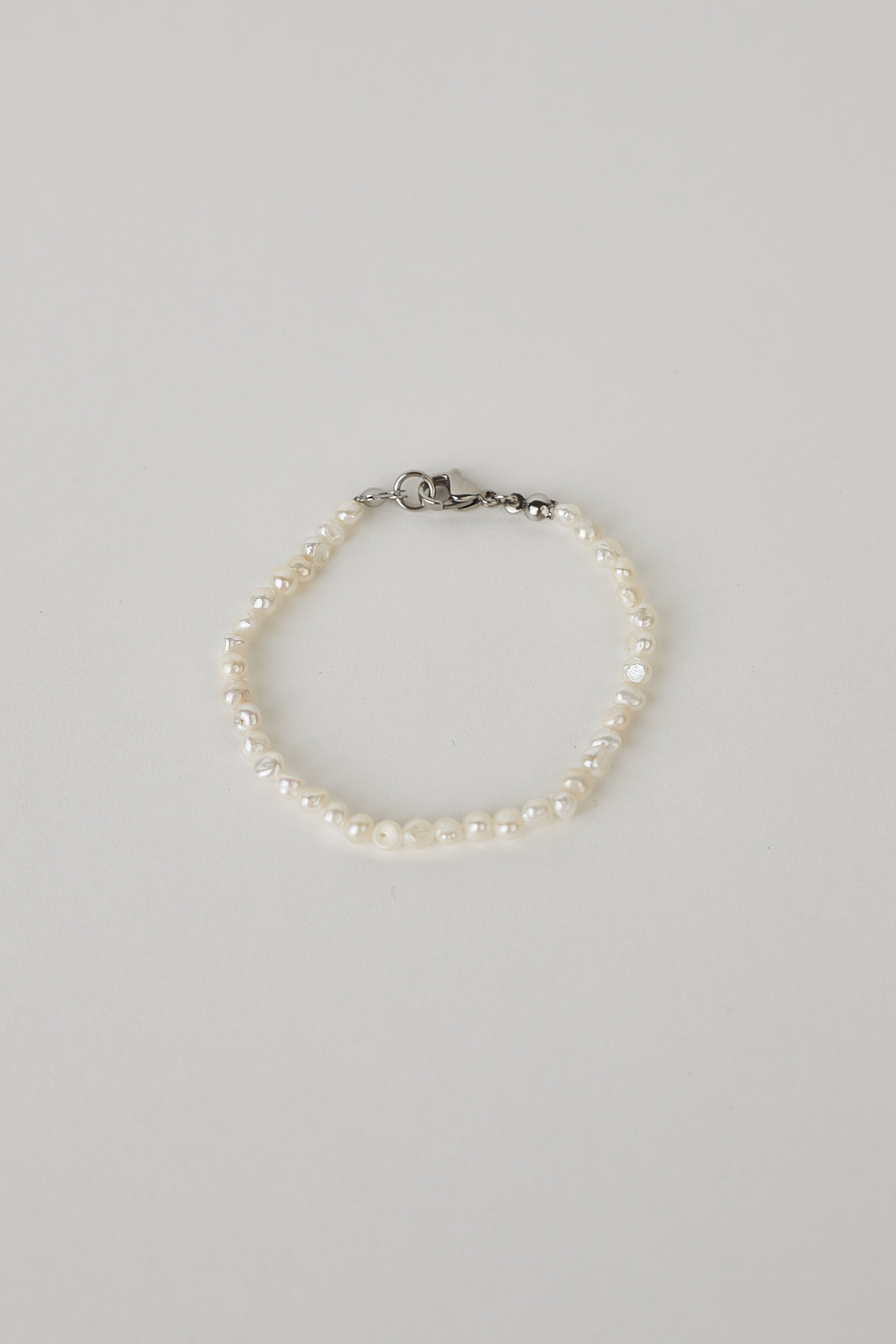 Pearl bracelet on a light gray background