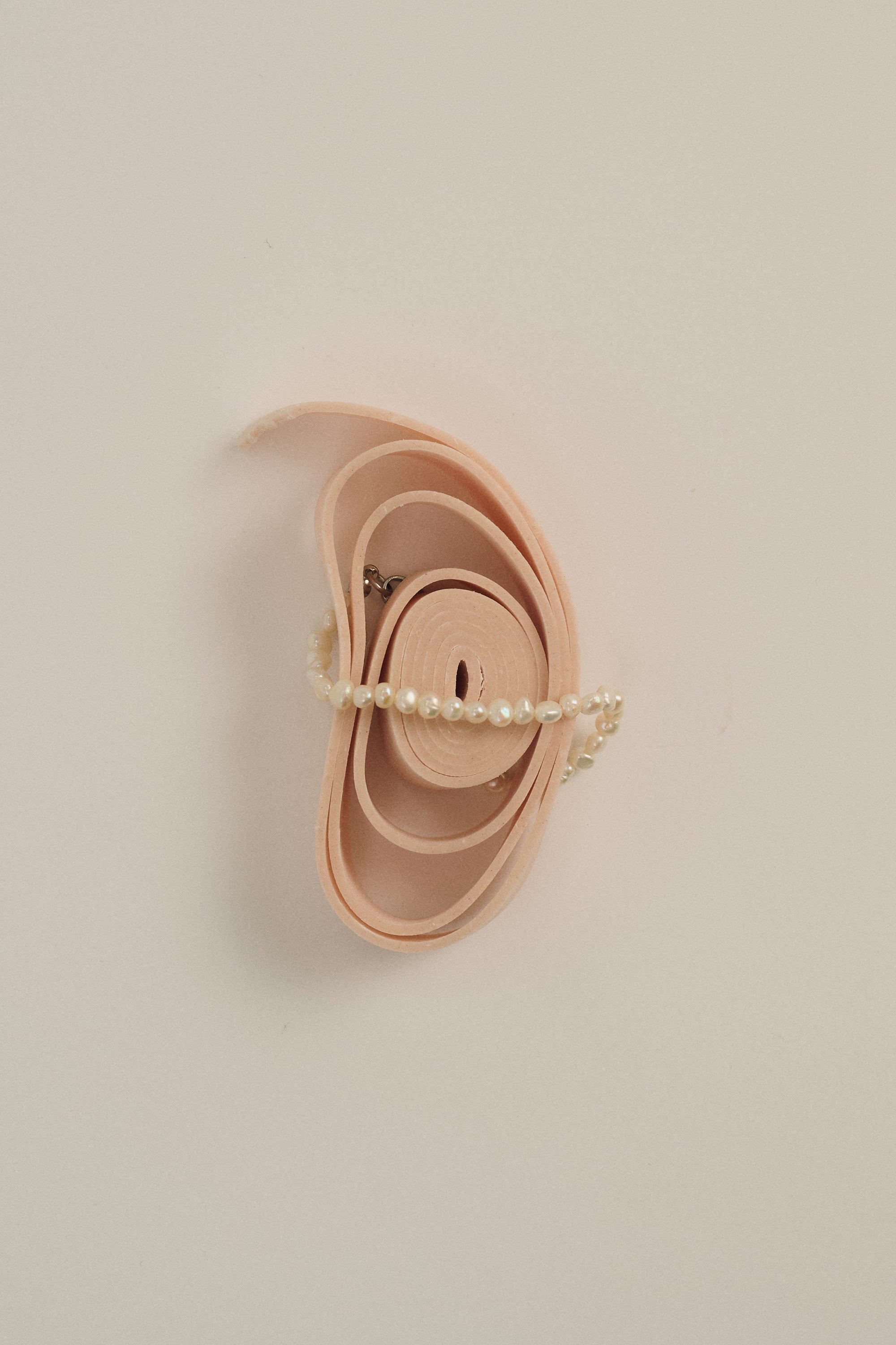 Minimal delicate freshwater pearl bracelet styled on soft beige background.