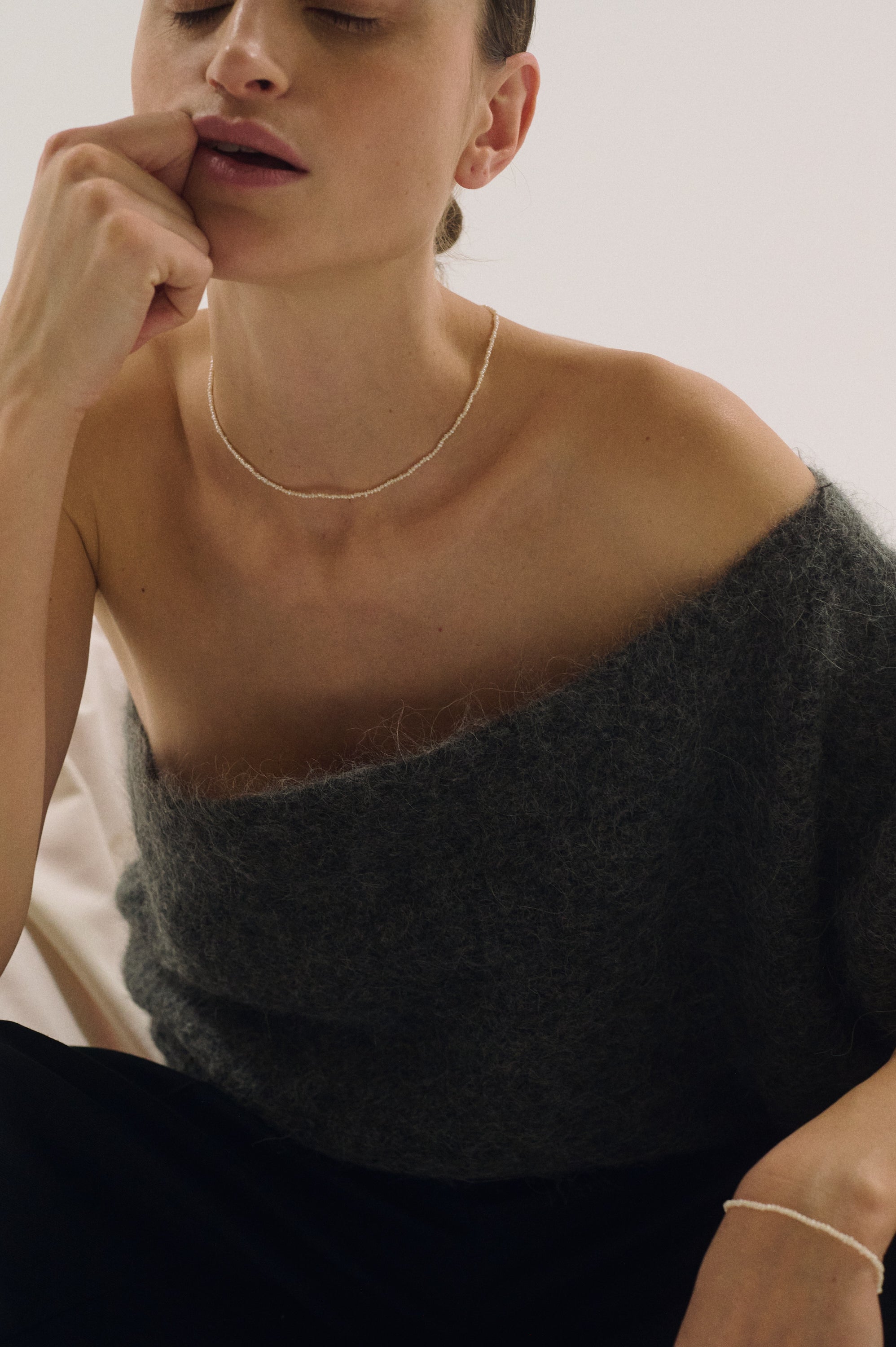 Delicate dainty pearl choker for women styled with grey mohair sweater