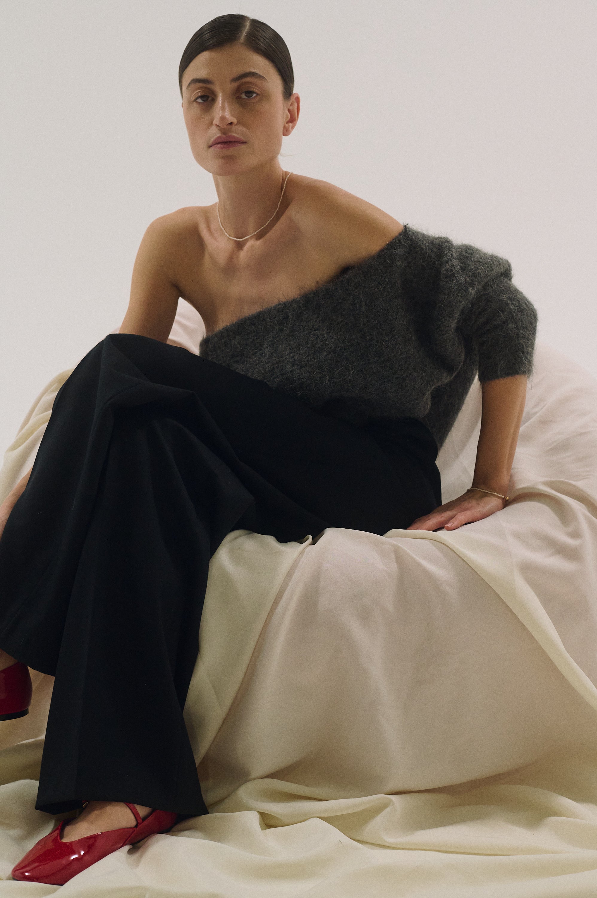 Model wearing extra small pearl choker with timeless black trousers look