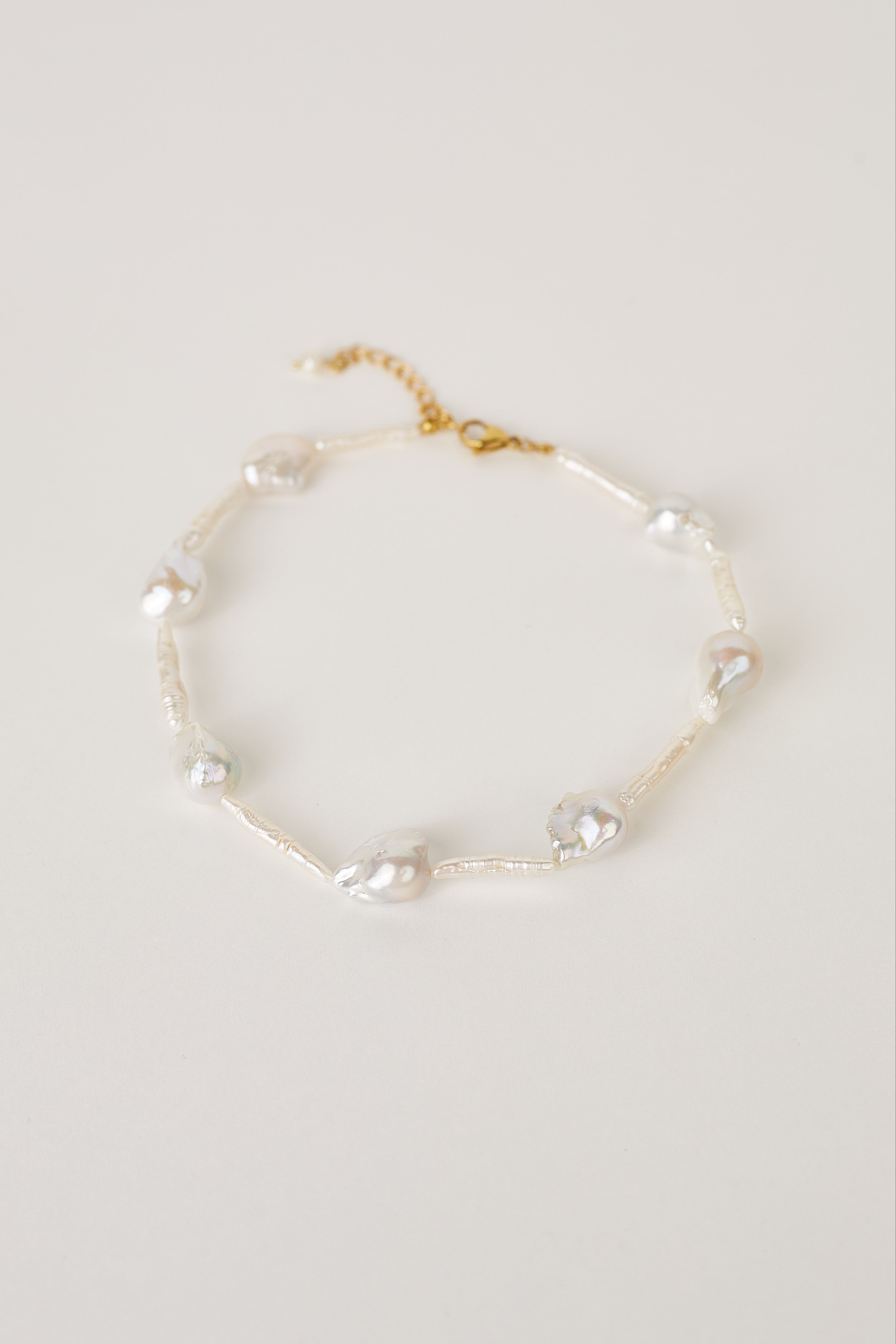 Natural freshwater pearl necklace in white background with gold clasp