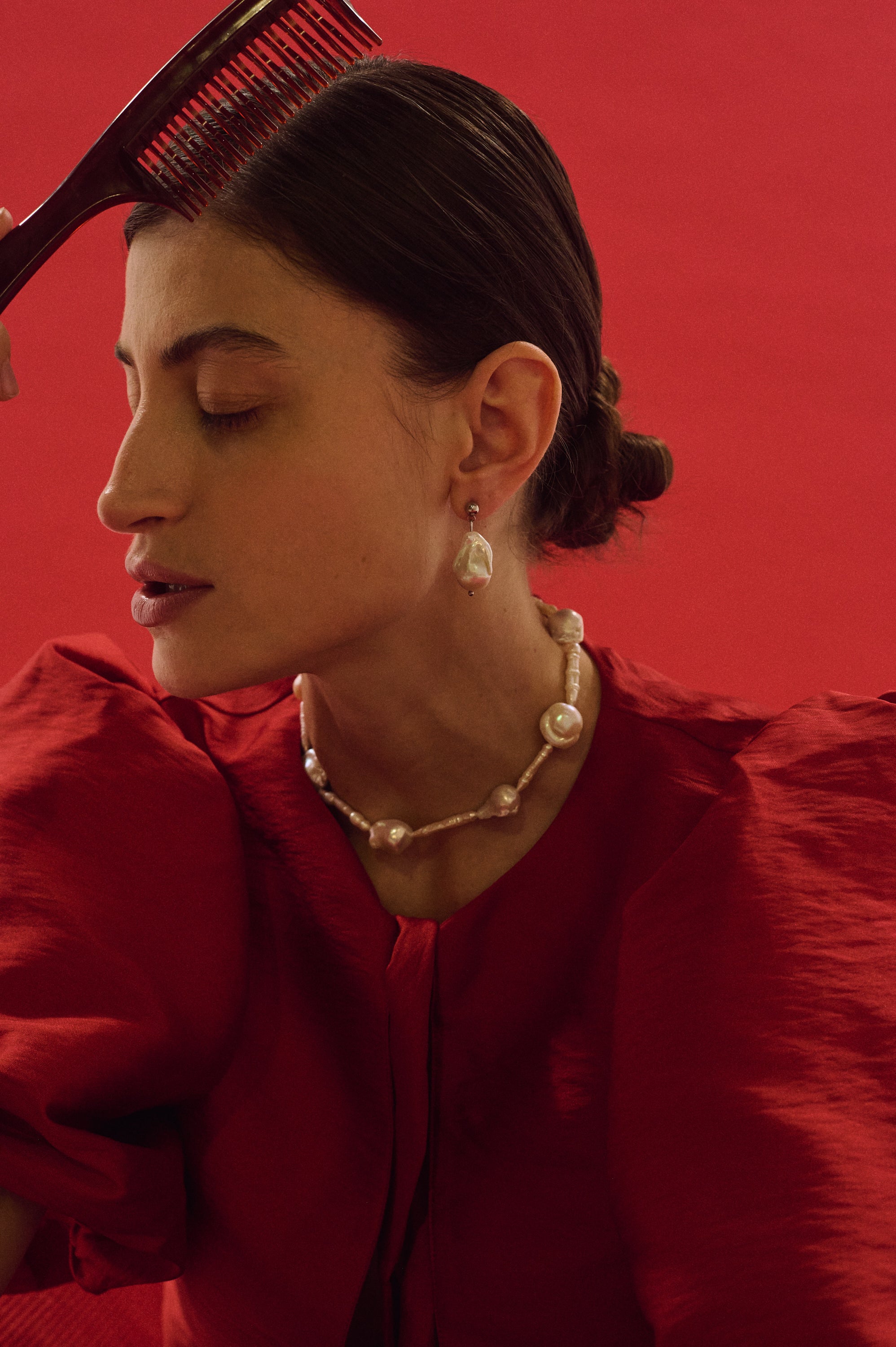 Close-up of baroque and elongated stick pearl necklace with matching earrings