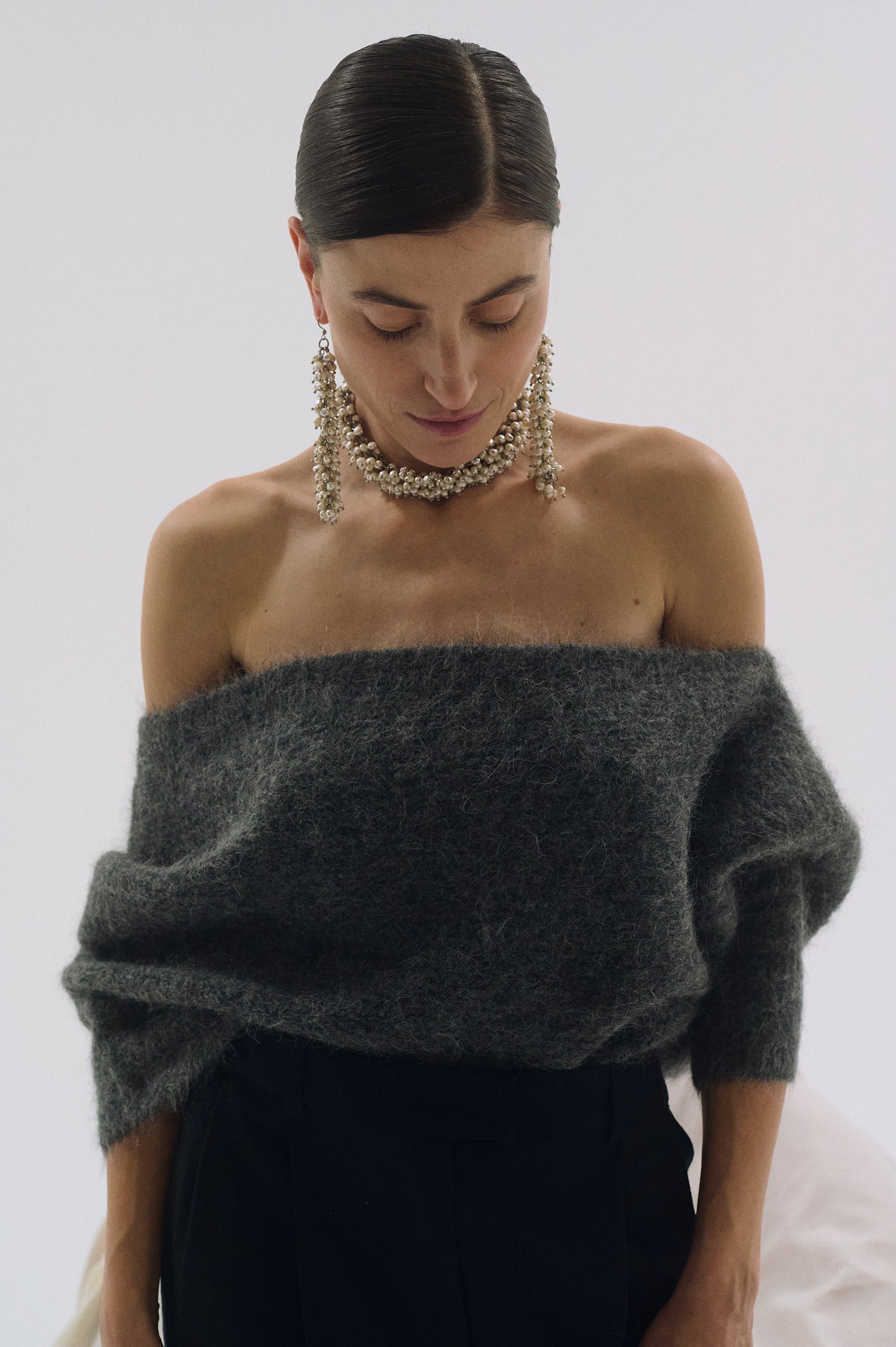 Elegant statement pearl earrings with bold, long dangle design