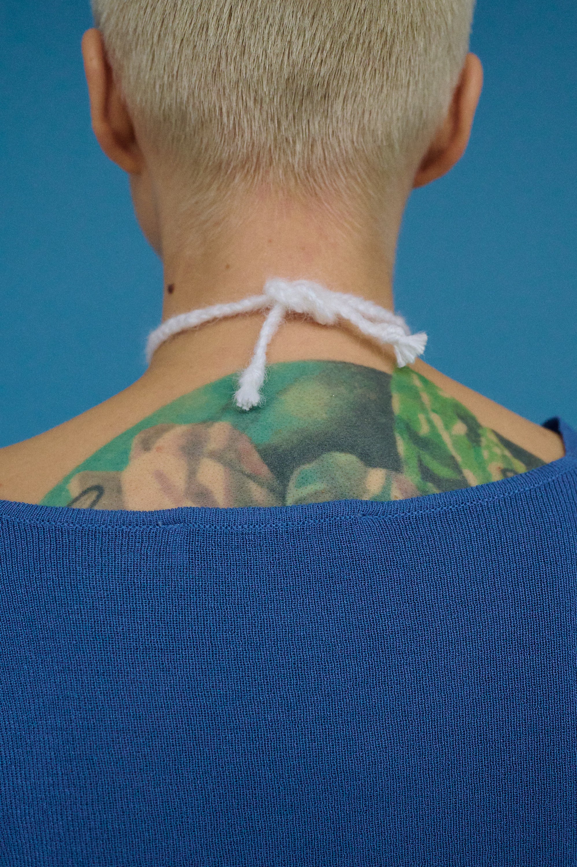 Back view of mohair wool choker tie with natural baroque pearl pendant.