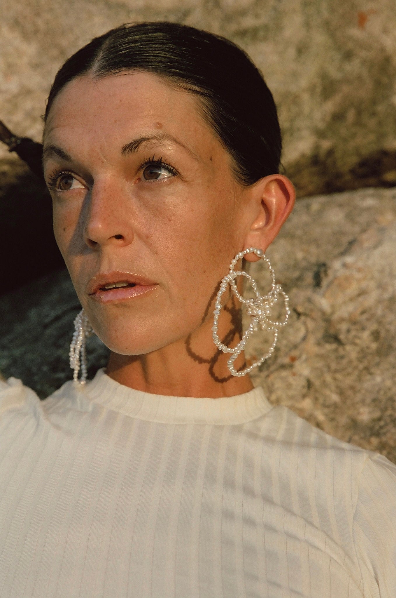 large white pearl flower earrings close-up on model