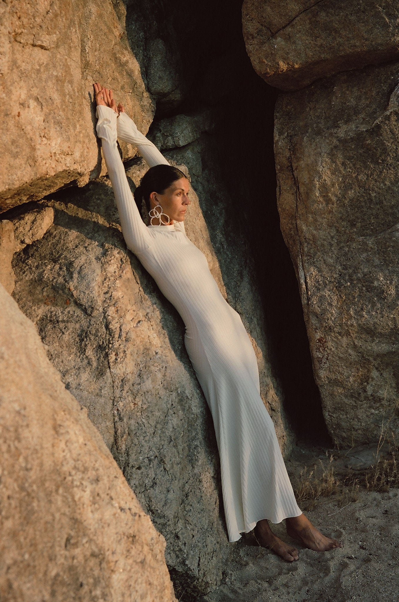 oversized flower pearl earrings styled with long white dress