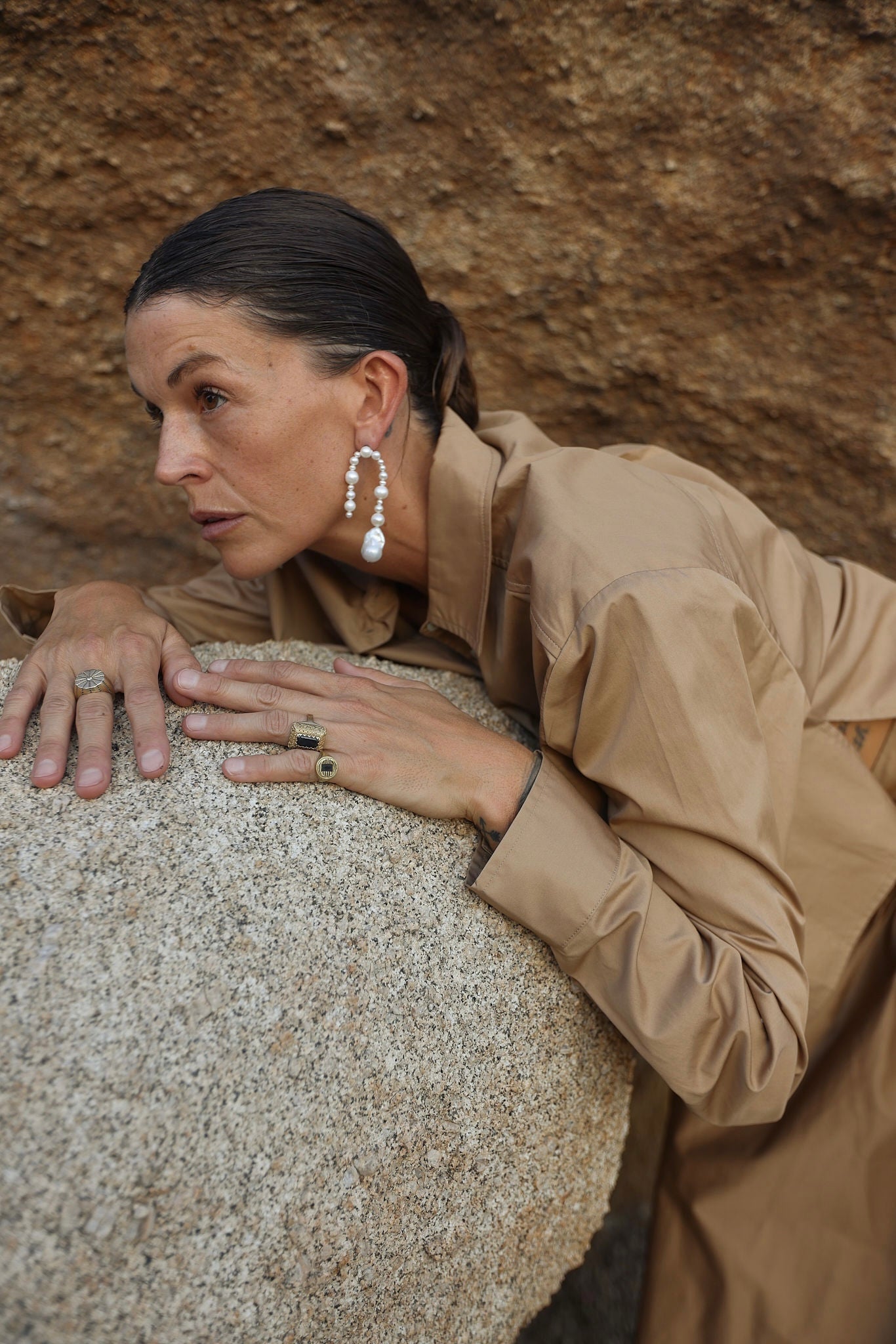 Model wearing long handmade pearl statement earrings outdoors