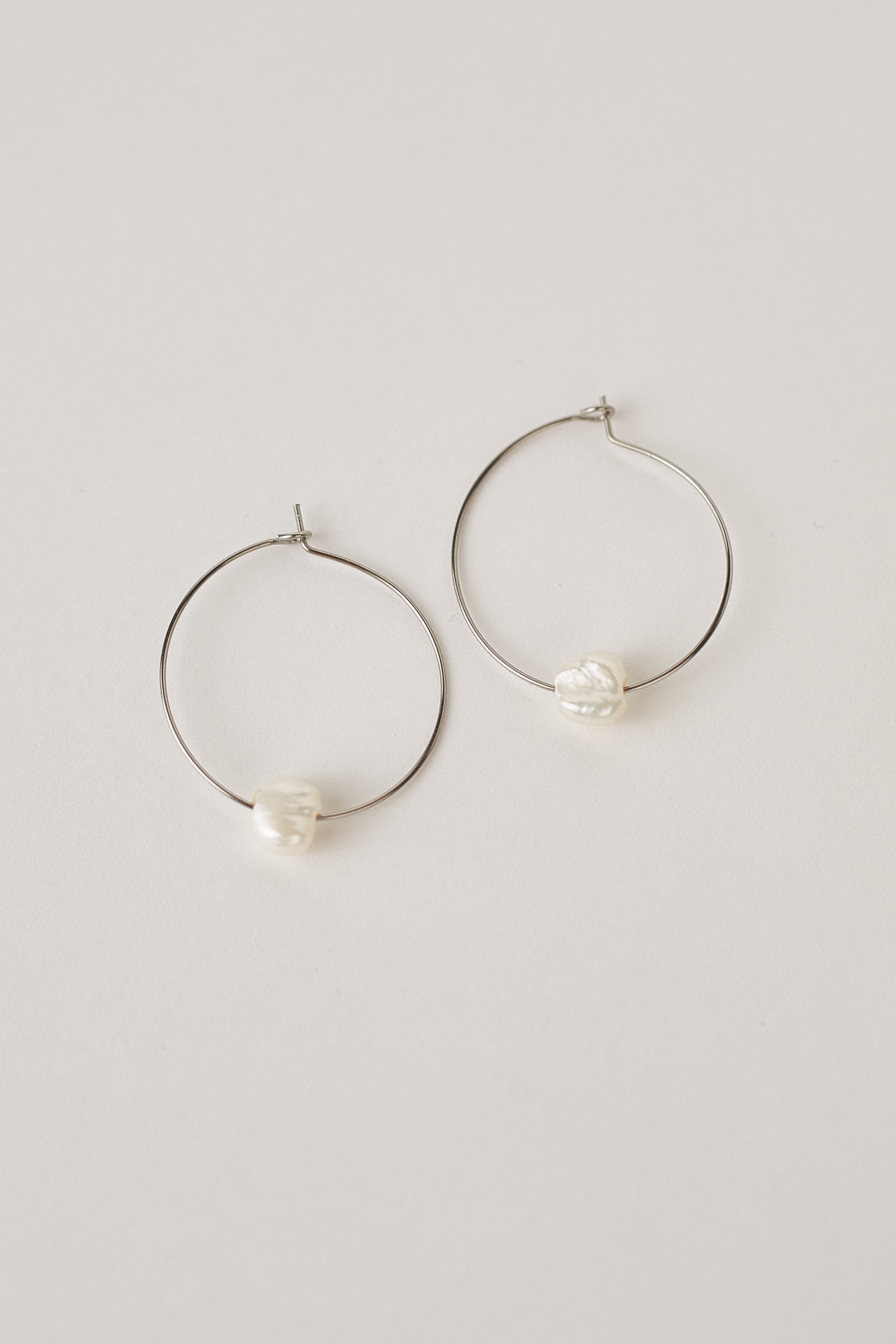 Silver hoop earrings with freshwater pearls