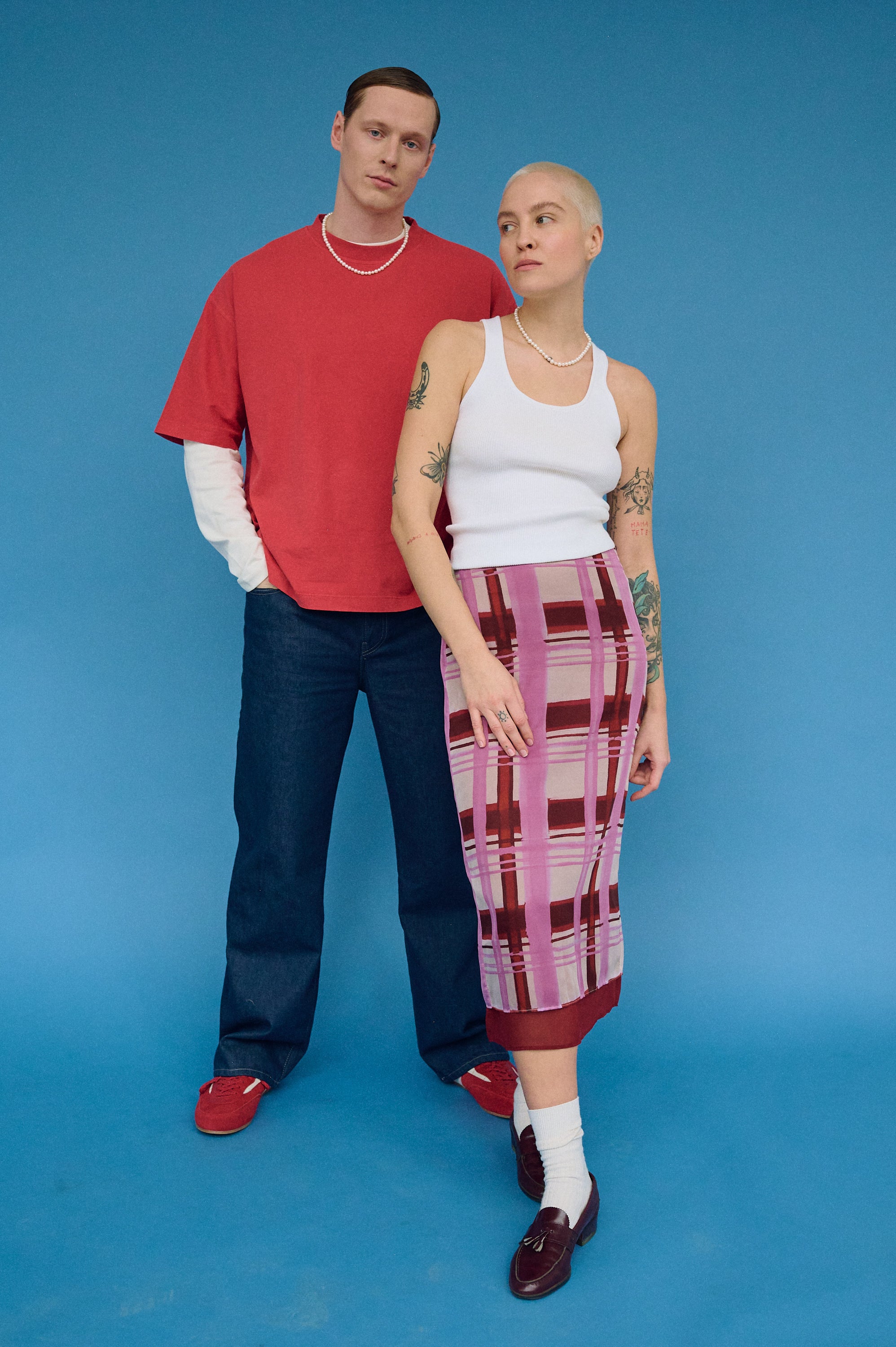 Couple wearing real pearl necklaces, men’s and women’s styles together.