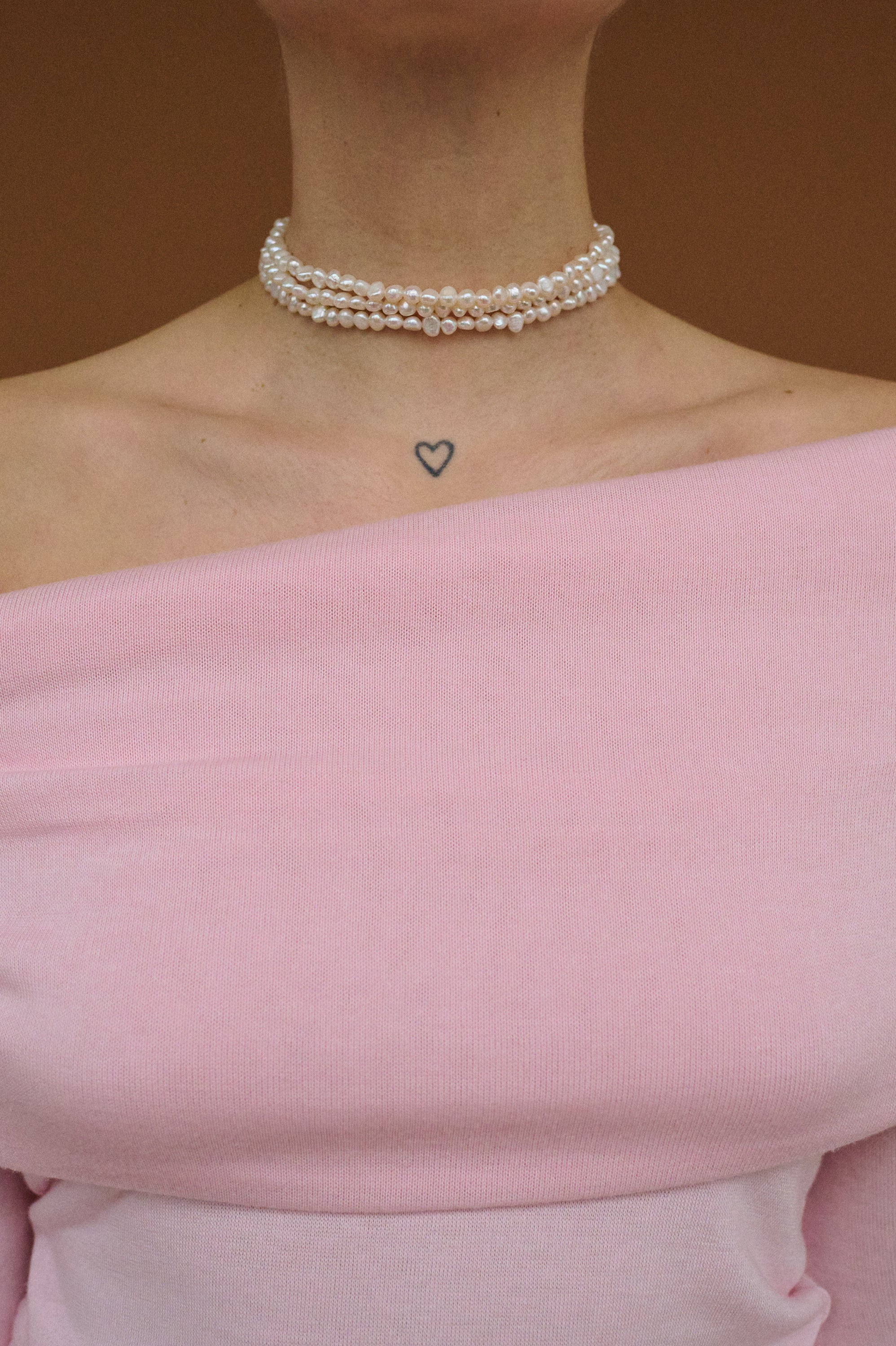 Close-up of natural freshwater pearl choker with three delicate strands.