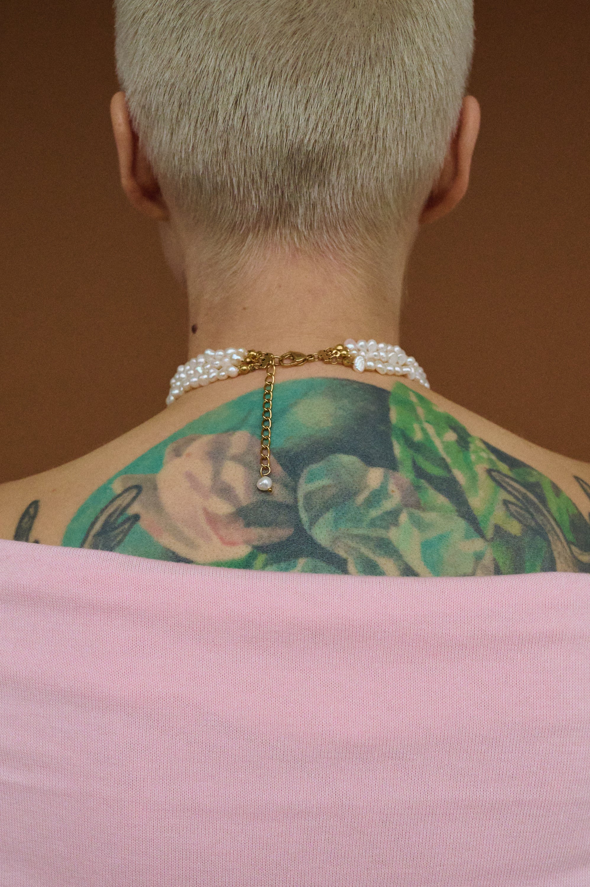 Back view of triple pearl choker with gold clasp and adjustable chain.