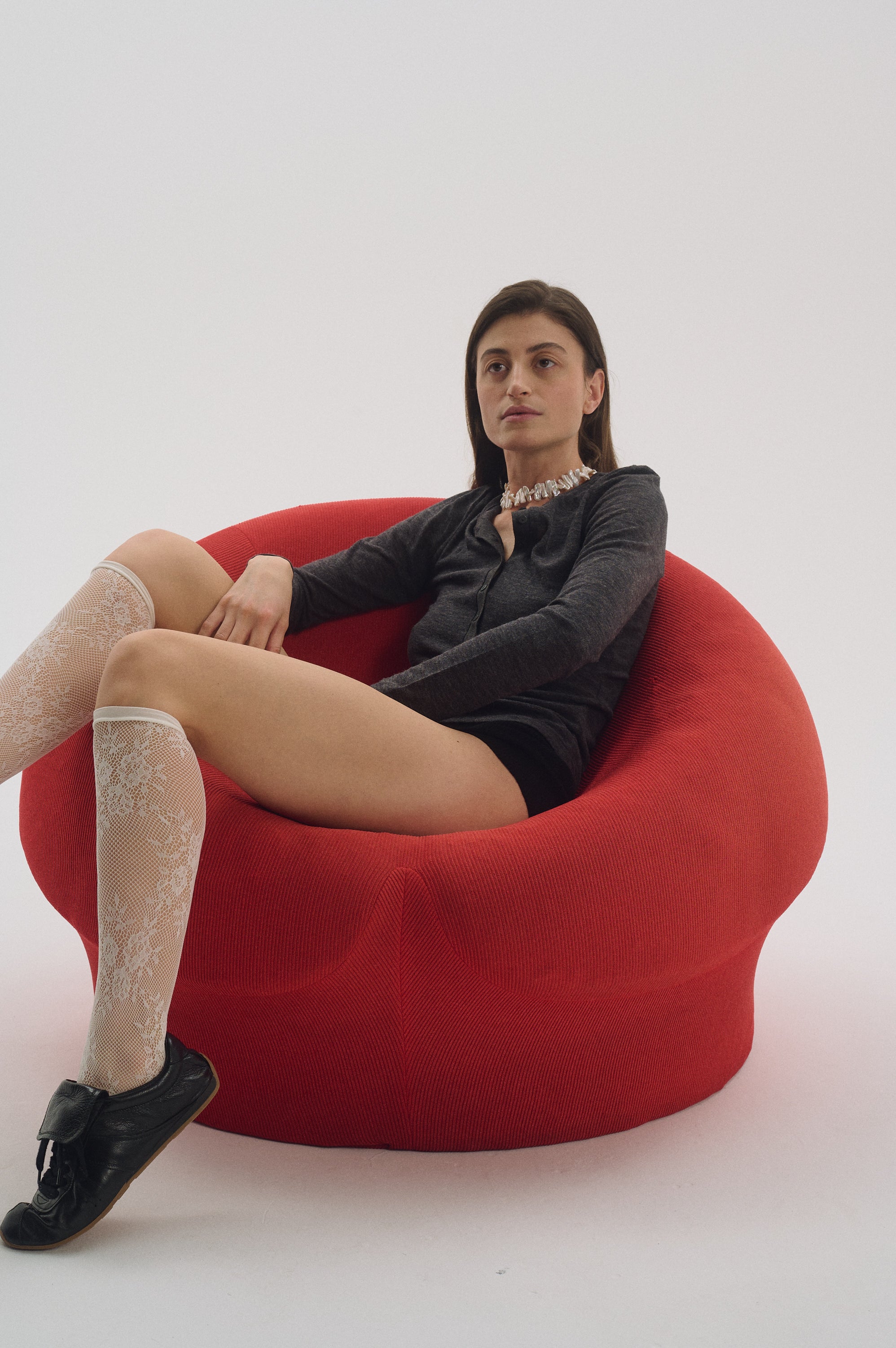 White Keshi pearl choker necklace for women on red chair.