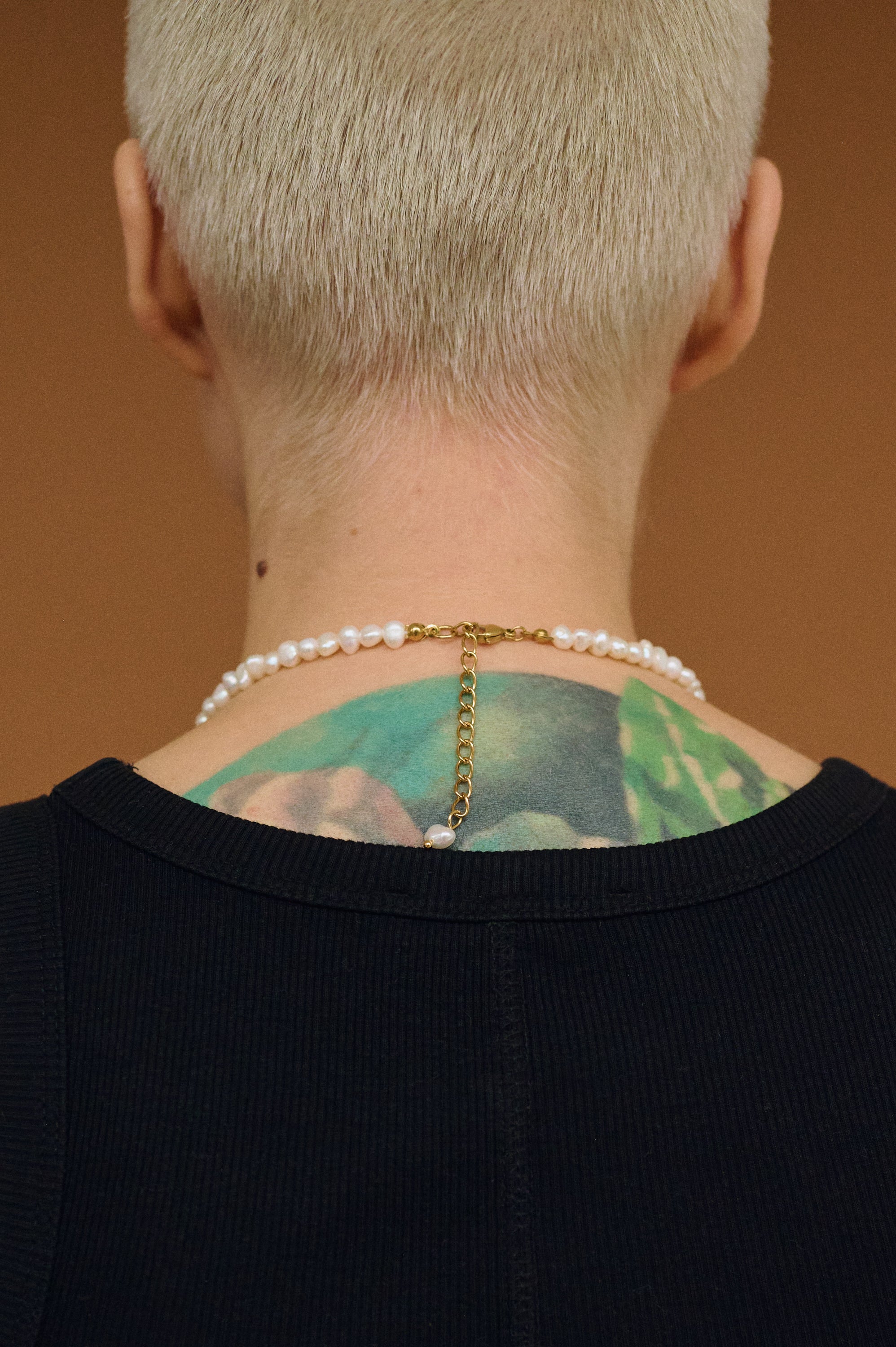 Back view of white pearl necklace with gold clasp