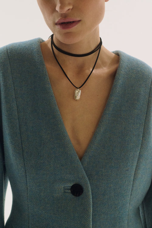 Model wearing black suede ribbon necklace with baroque pearl pendant – elegant minimalist choker