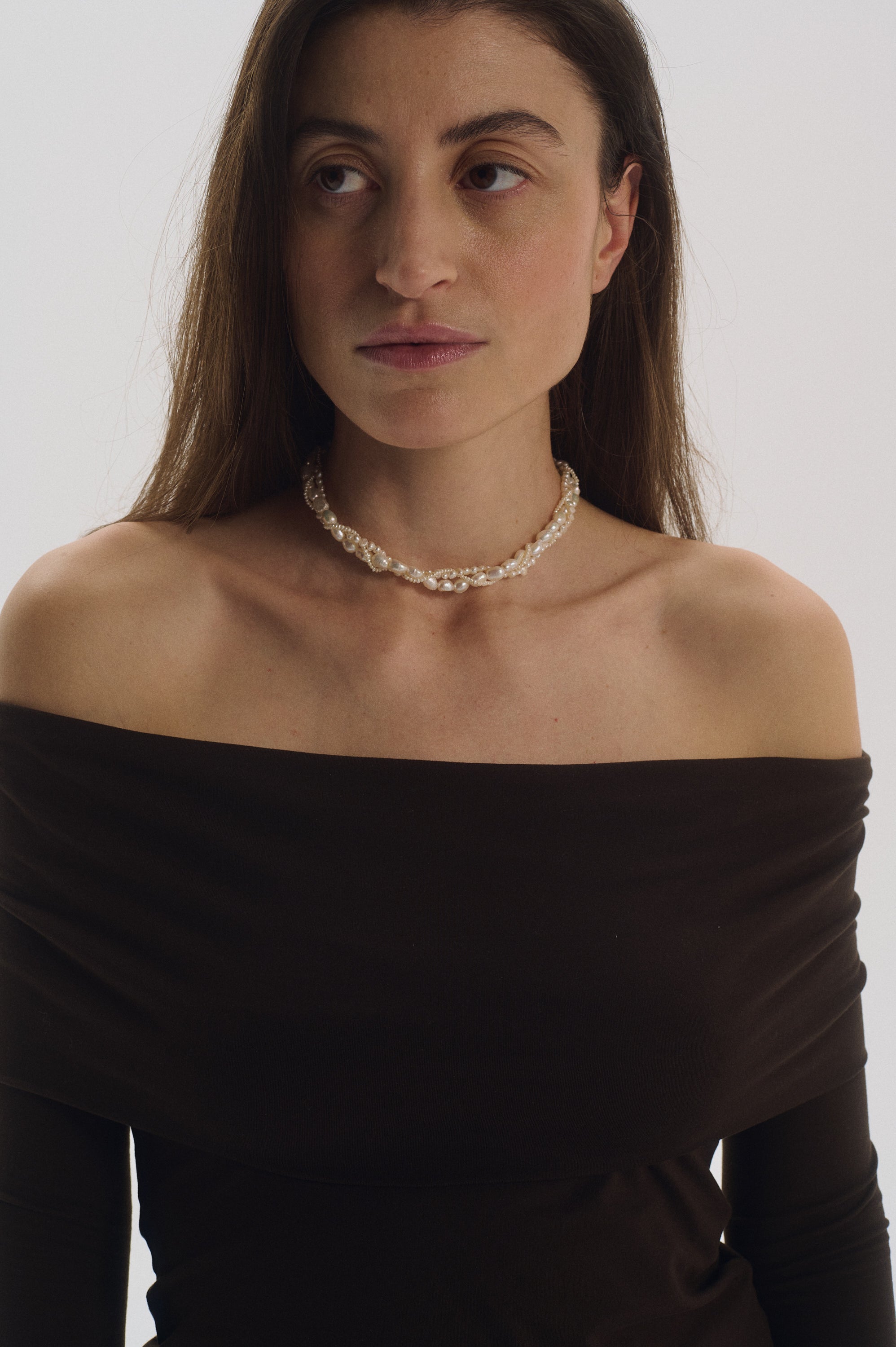 Elegant pearl choker styled with off-shoulder outfit