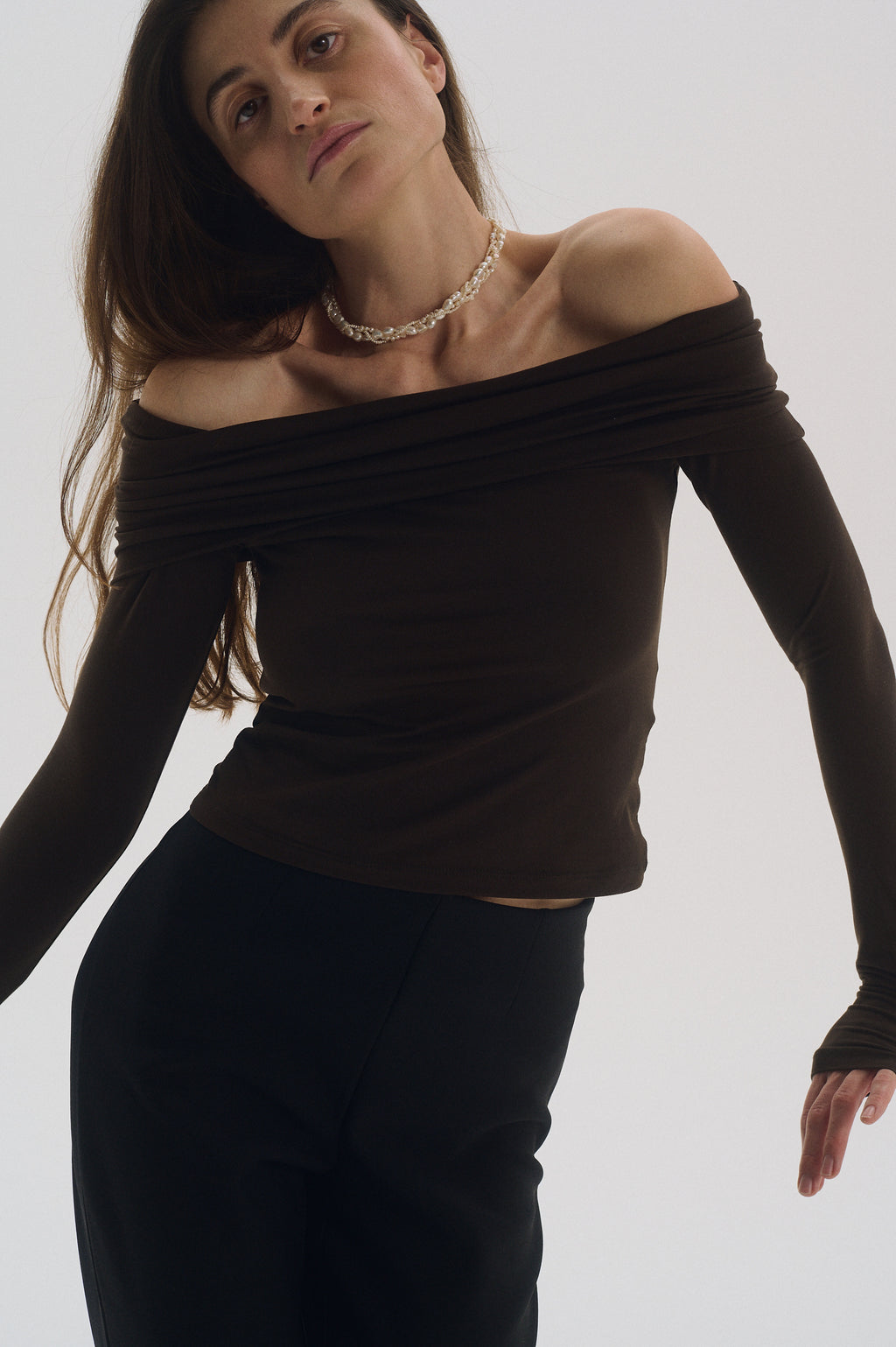 Close-up of triple braided pearl choker necklace on model