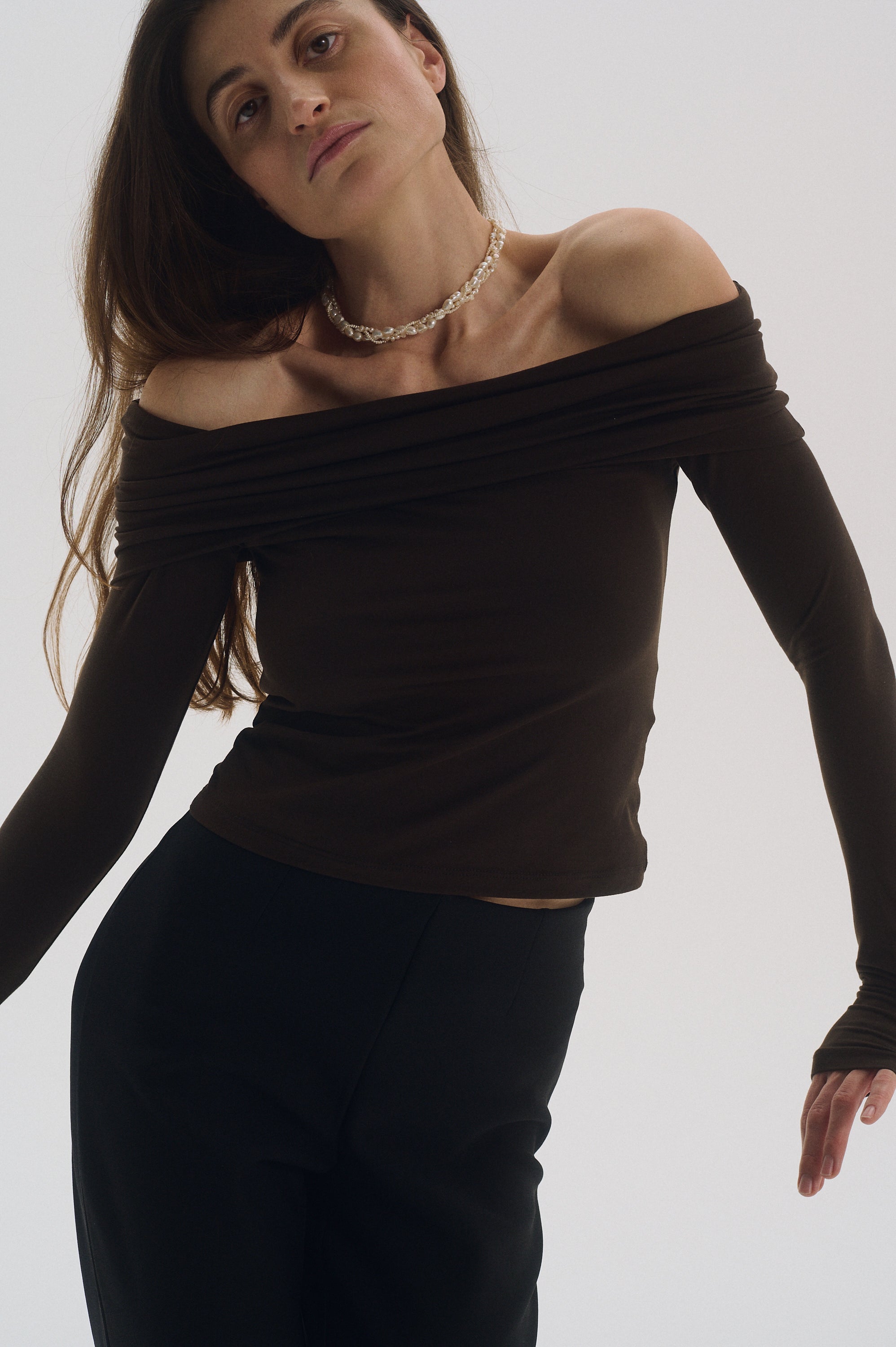 Close-up of triple braided pearl choker necklace on model