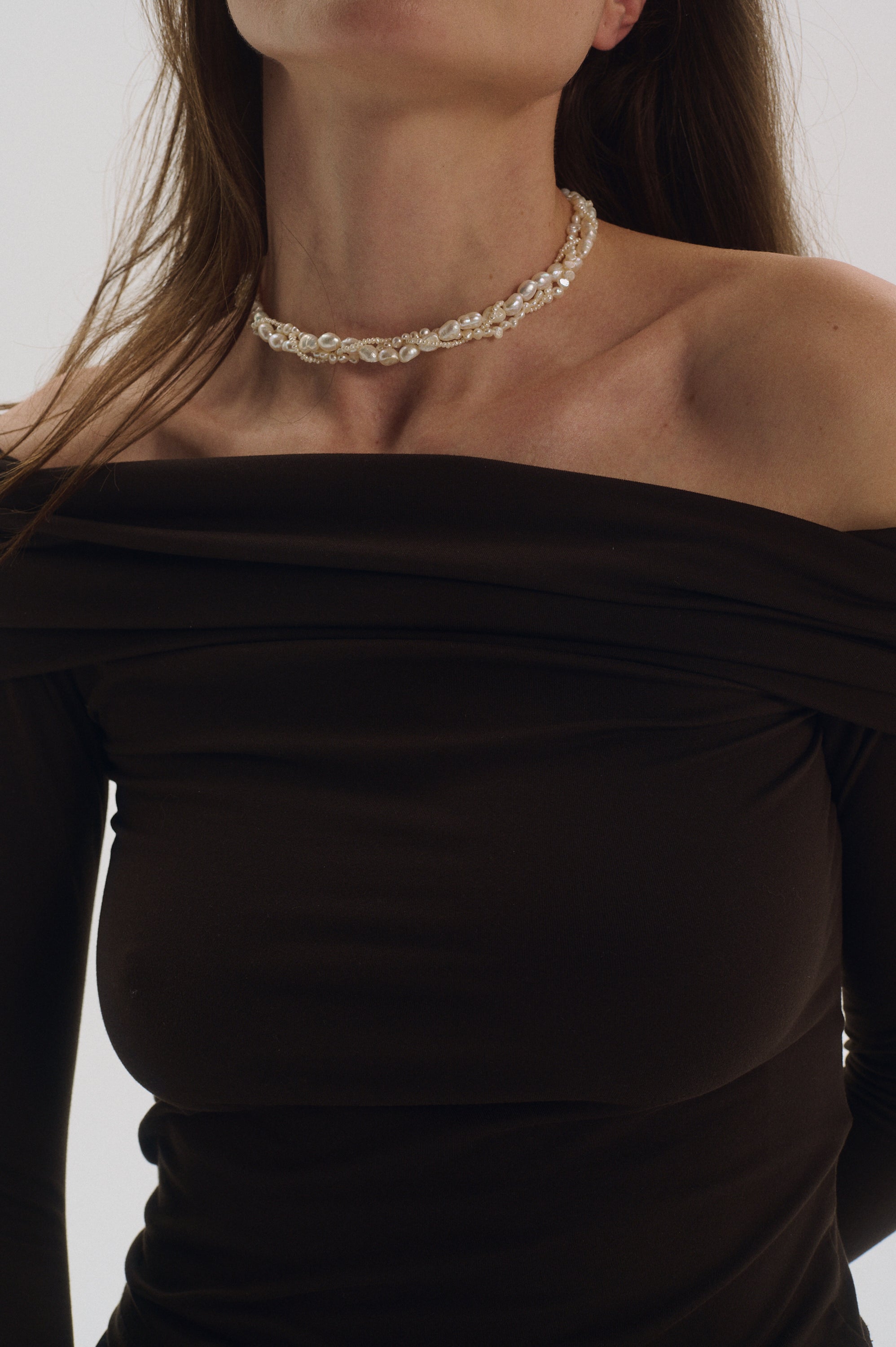 Model wearing triple braided freshwater pearl choker UGNÈS STORY