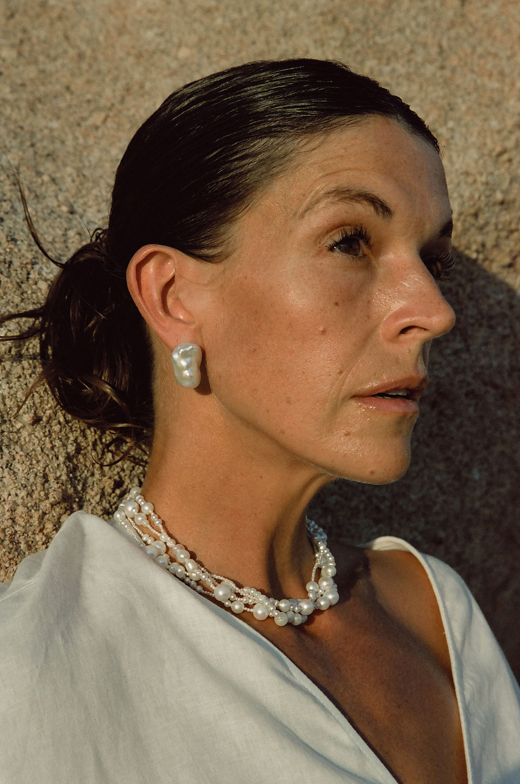layered white pearl necklace creating modern fashion look