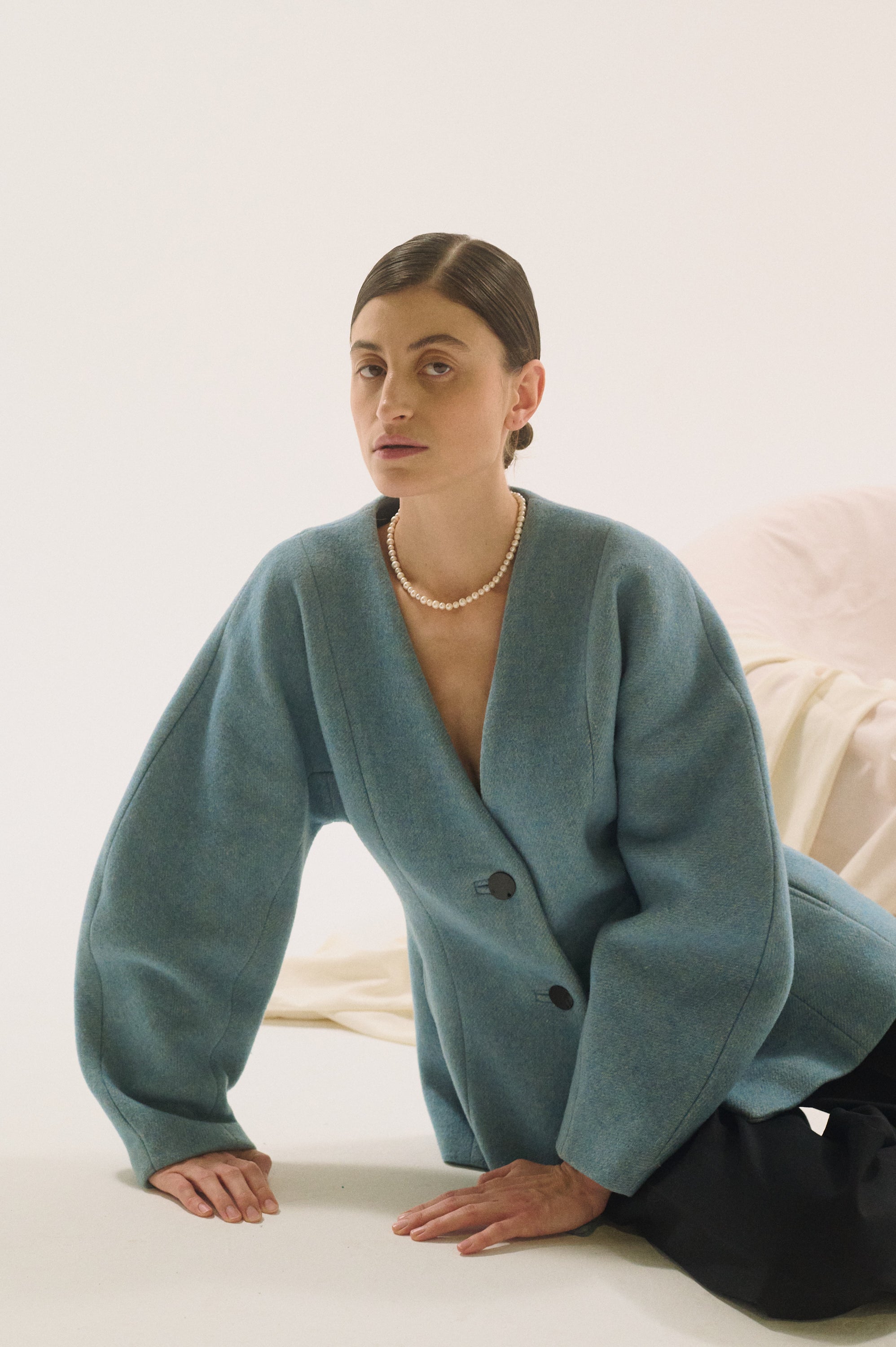 Close-up of classic round pearls on neckline – UGNÈS STORY