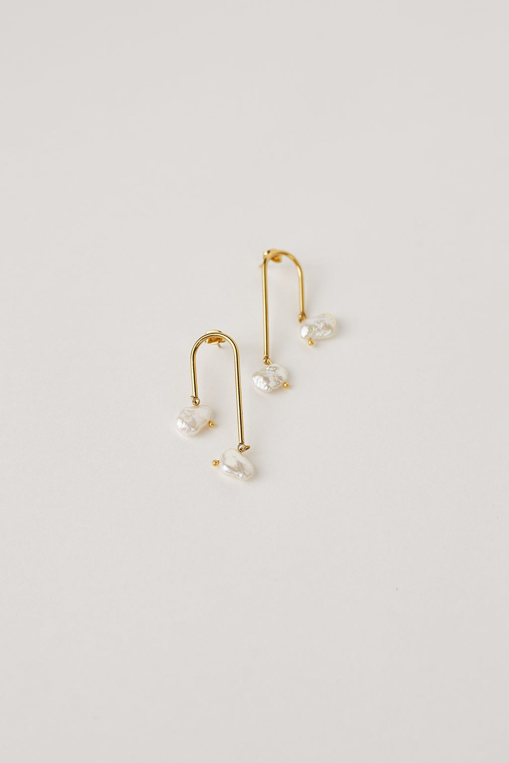Gold dangling Keshi pearl earrings with natural pearls
