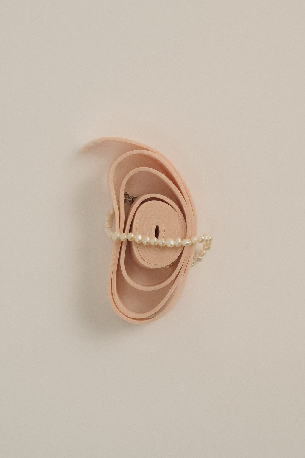 Minimal delicate freshwater pearl bracelet styled on soft beige background.