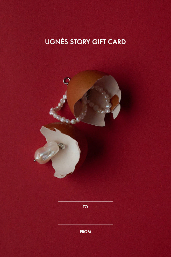 Ugnès Story digital gift card with pearls and broken eggshell on red background