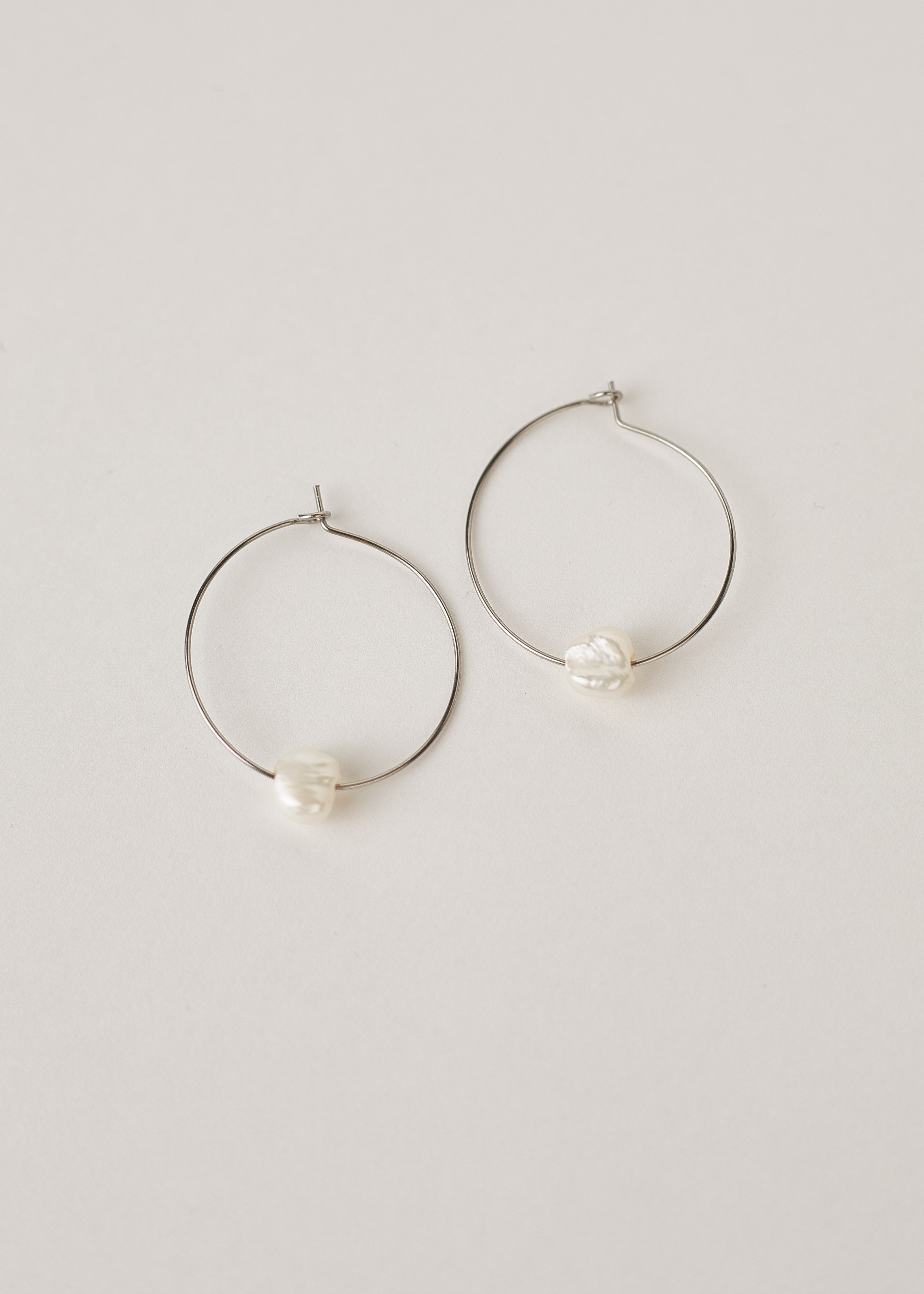 Silver hoop earrings with freshwater pearls