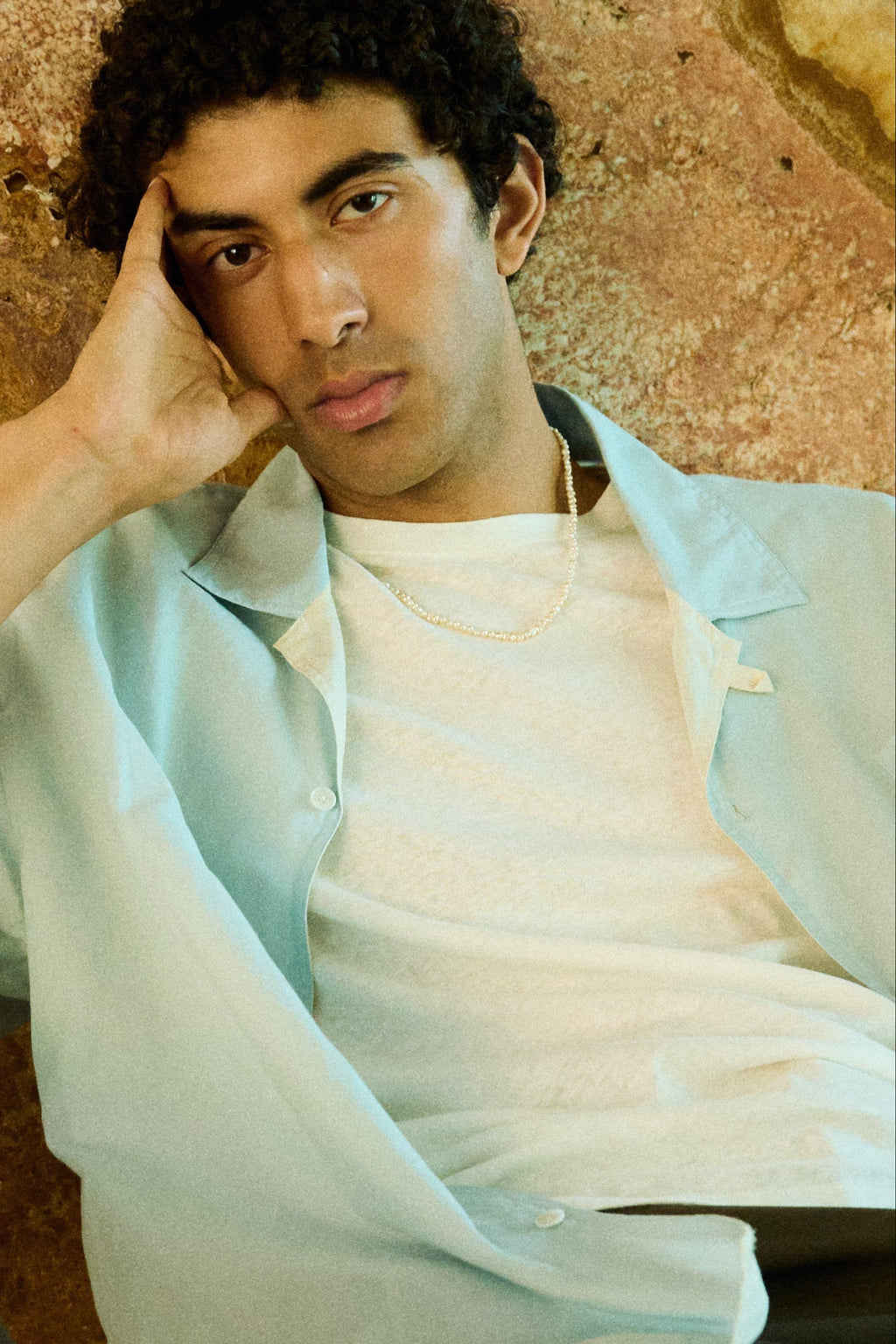 Man wearing a men’s nugget freshwater pearl necklace with small white pearls.