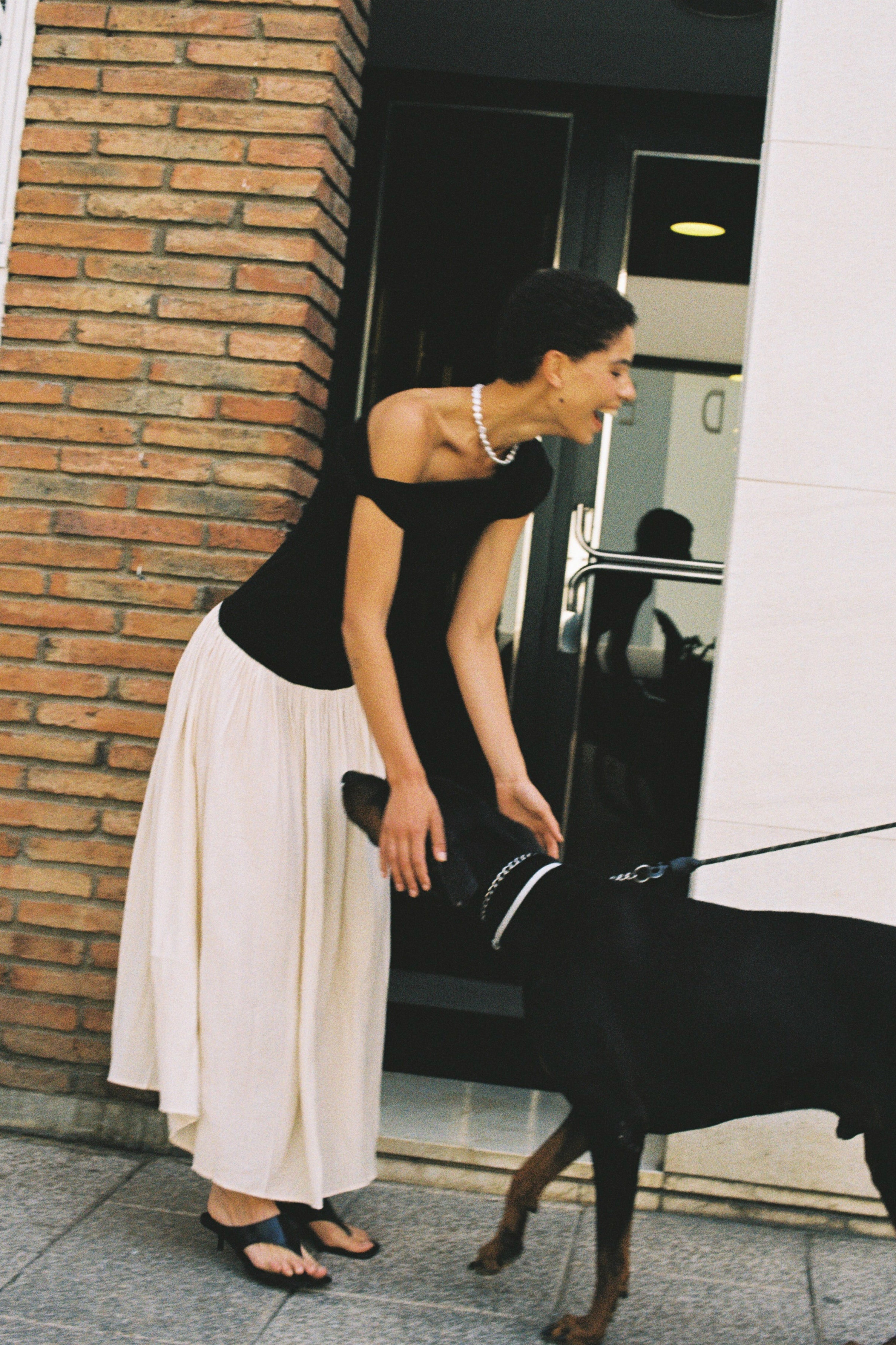 Coin freshwater pearl necklace styled with a minimal black top.