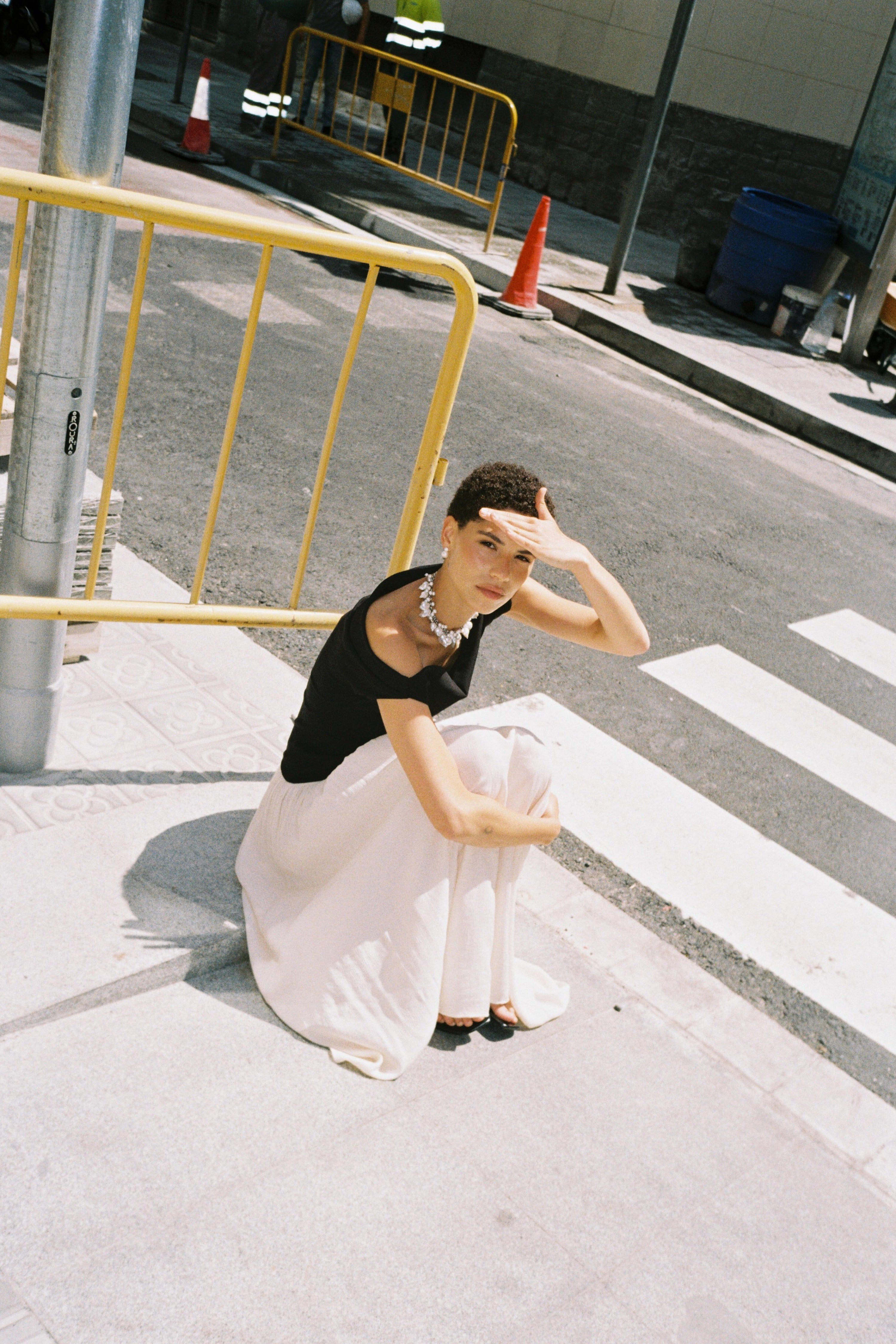 Statement pearl choker styled with a black off-shoulder top.
