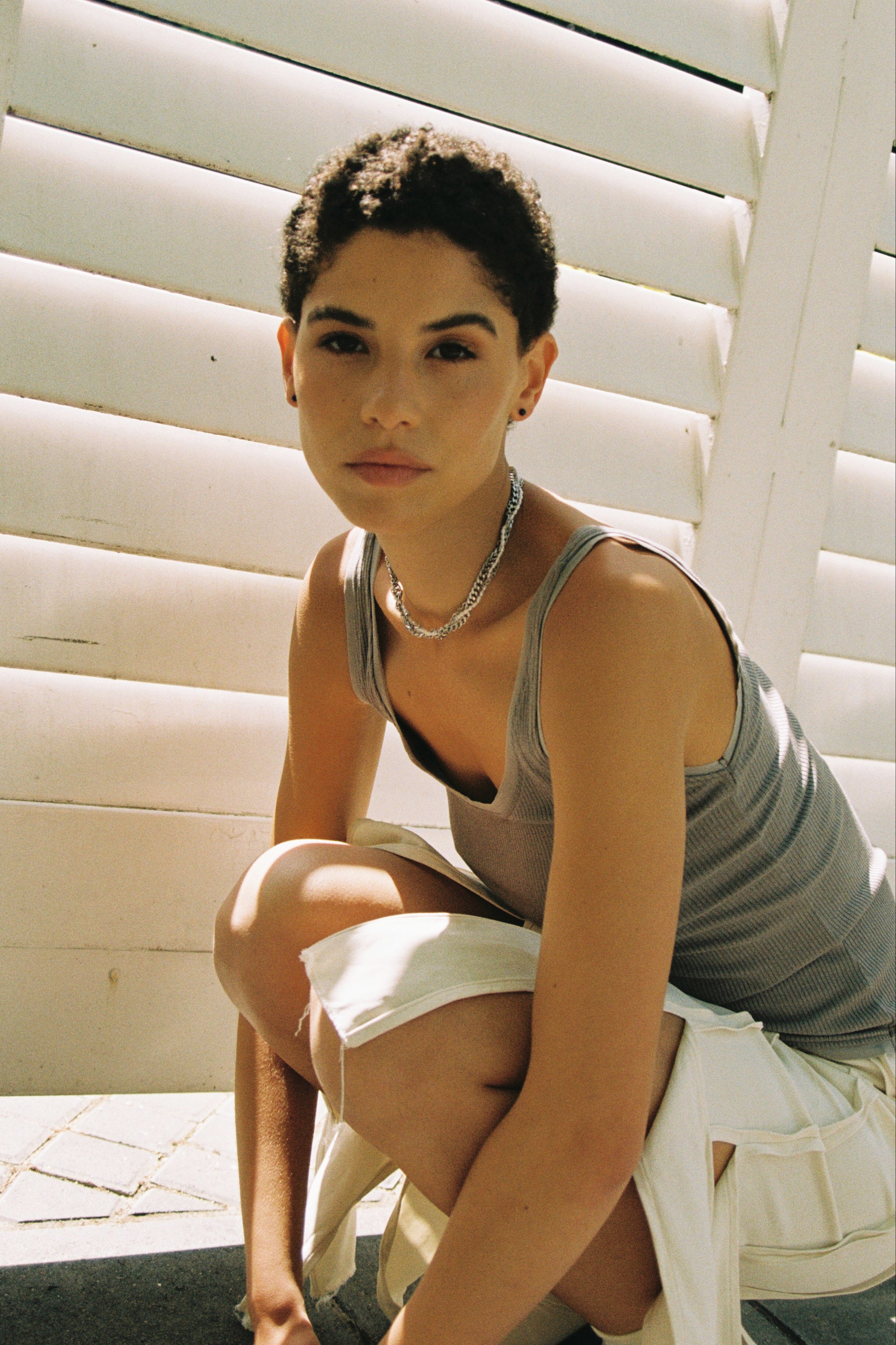 Braided pearl and chain choker styled with a minimal grey top.