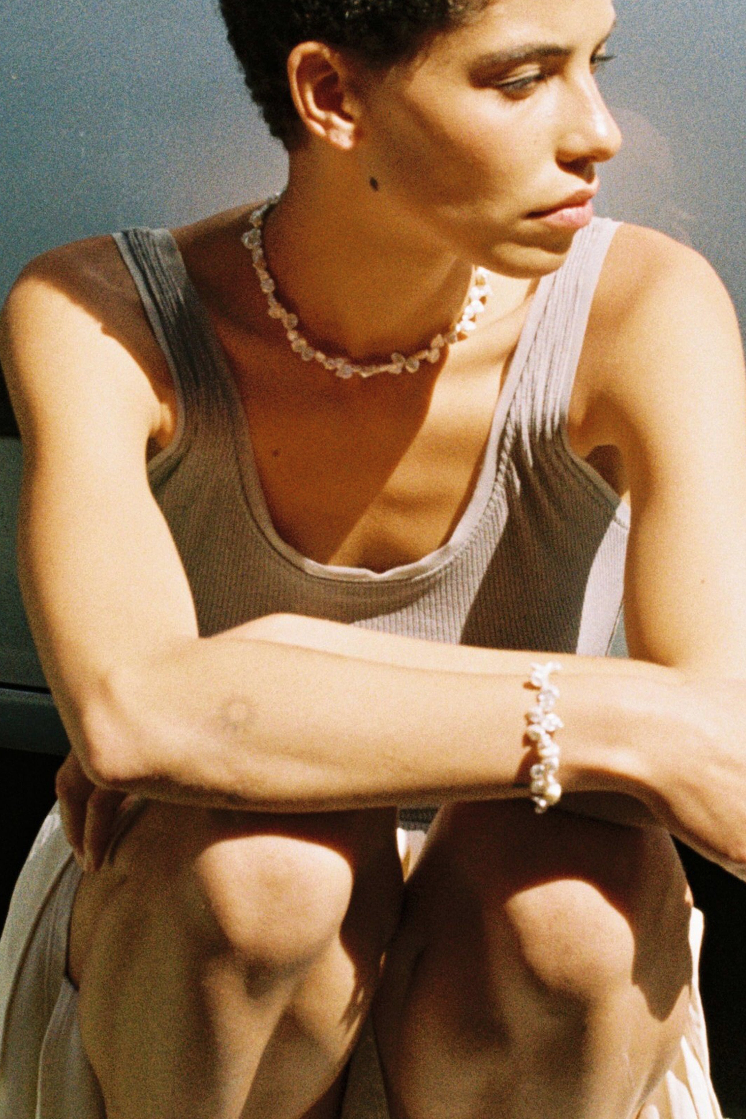 Model wearing a matching drop freshwater pearl necklace and bracelet set.