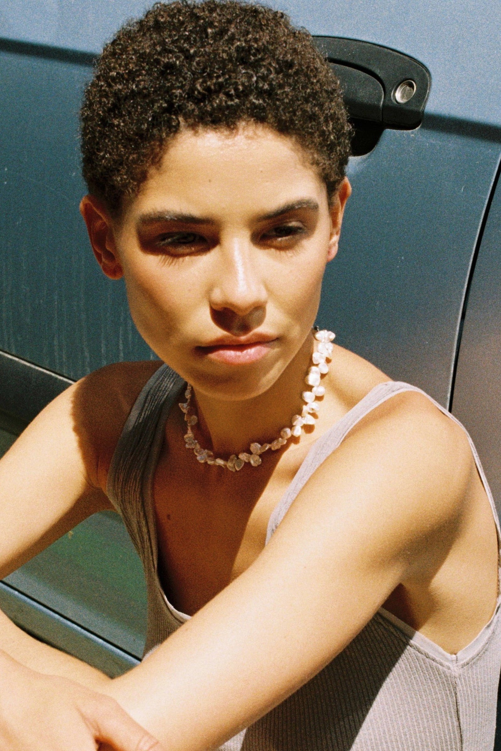Model wearing a drop freshwater pearl necklace with softly irregular natural pearls.