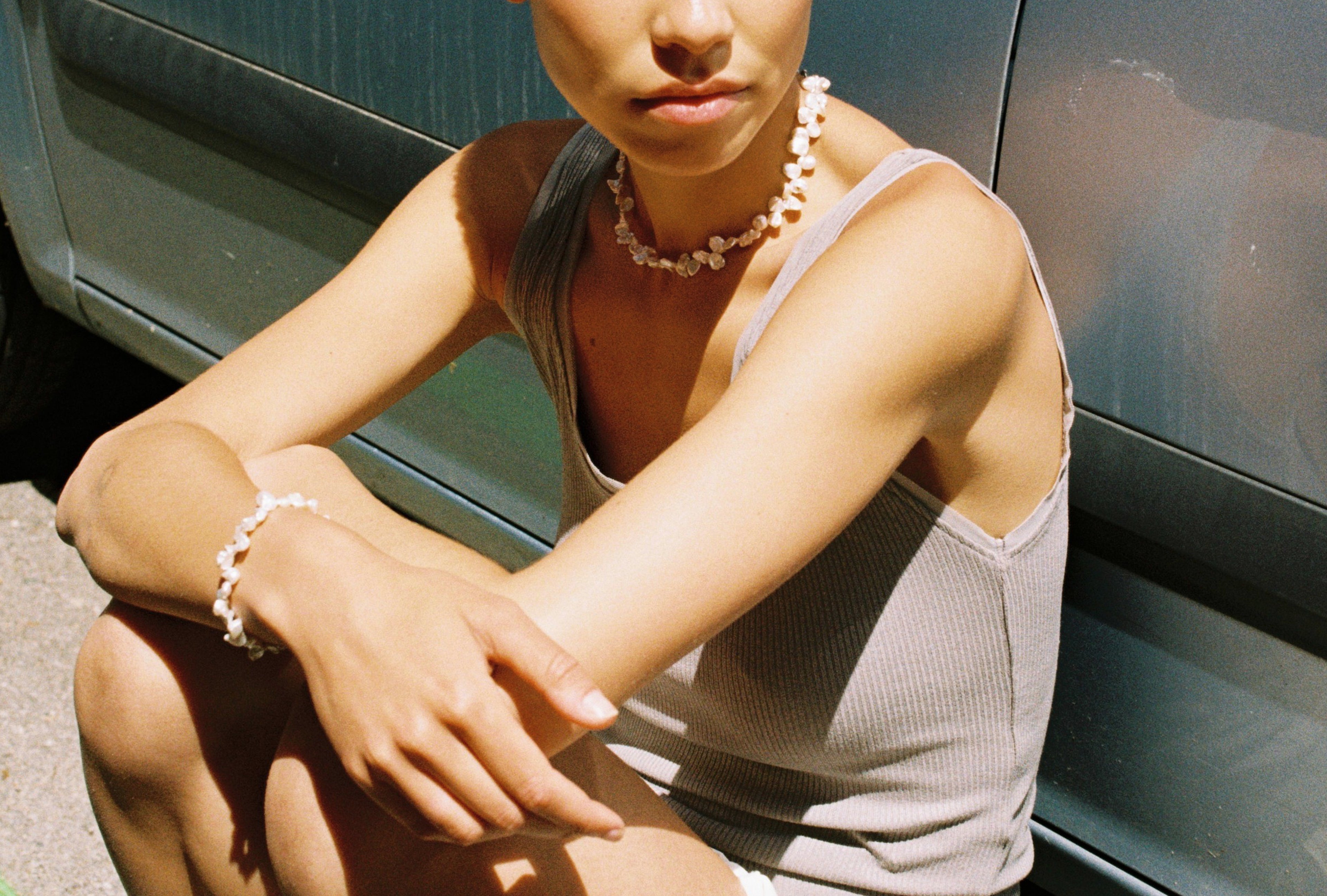 Model wearing a matching drop freshwater pearl necklace and bracelet set.