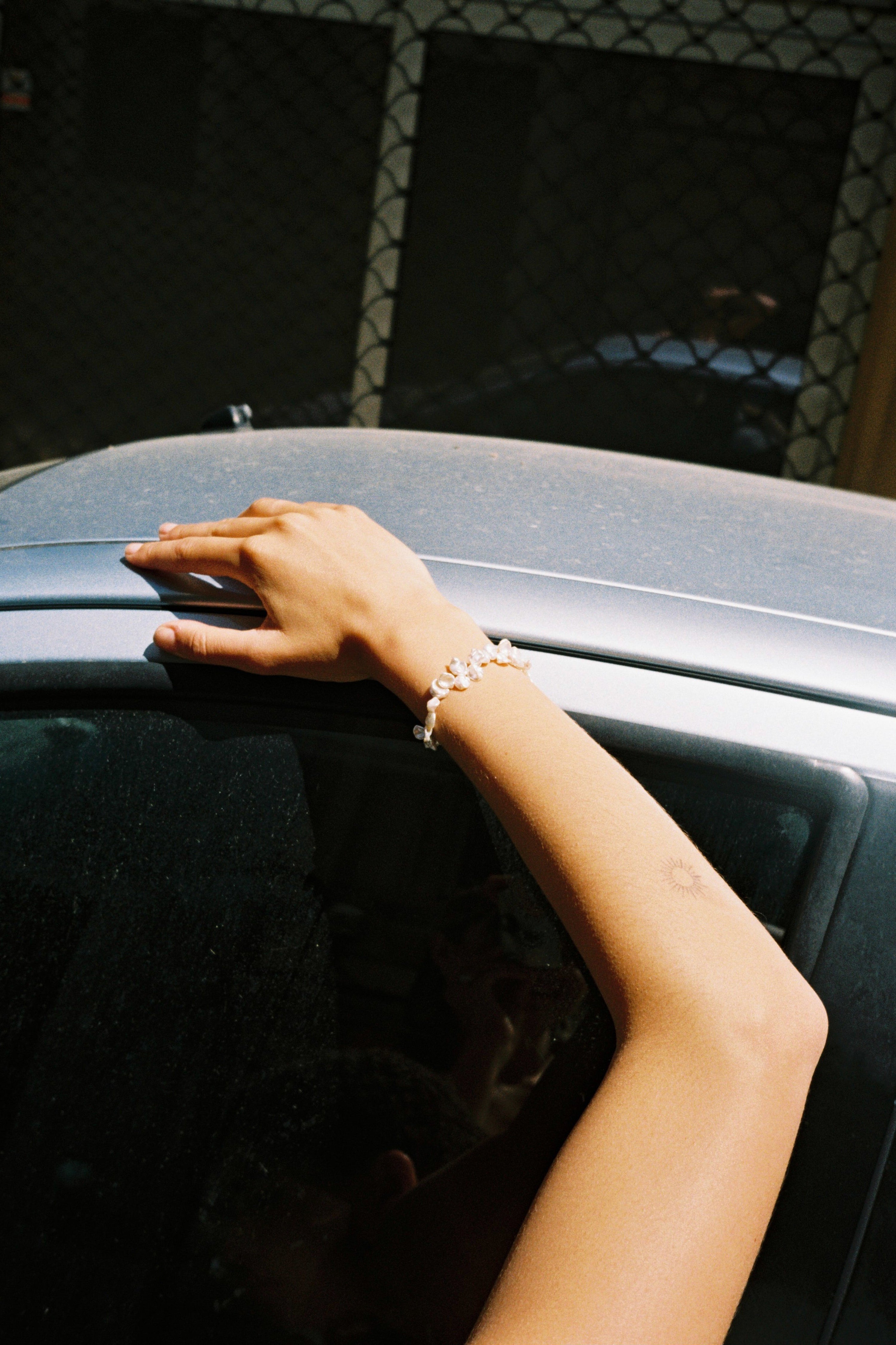 Drop-shaped freshwater pearl bracelet with natural irregular pearls and stainless steel clasp.