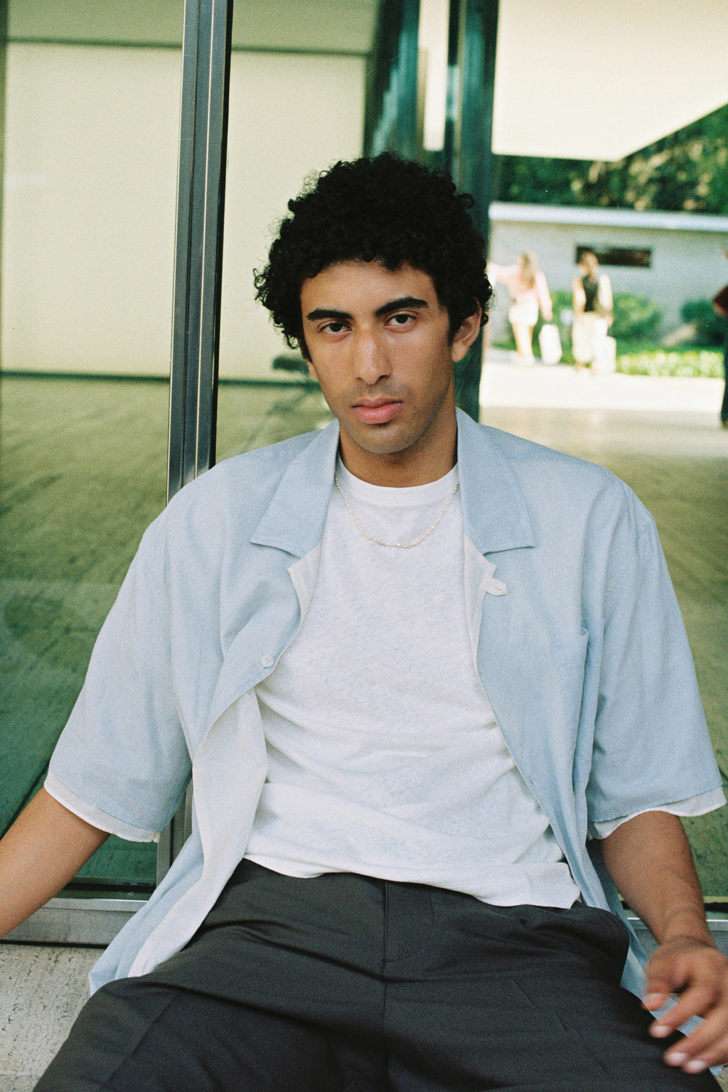 Man wearing a men’s nugget freshwater pearl necklace with small white pearls.
