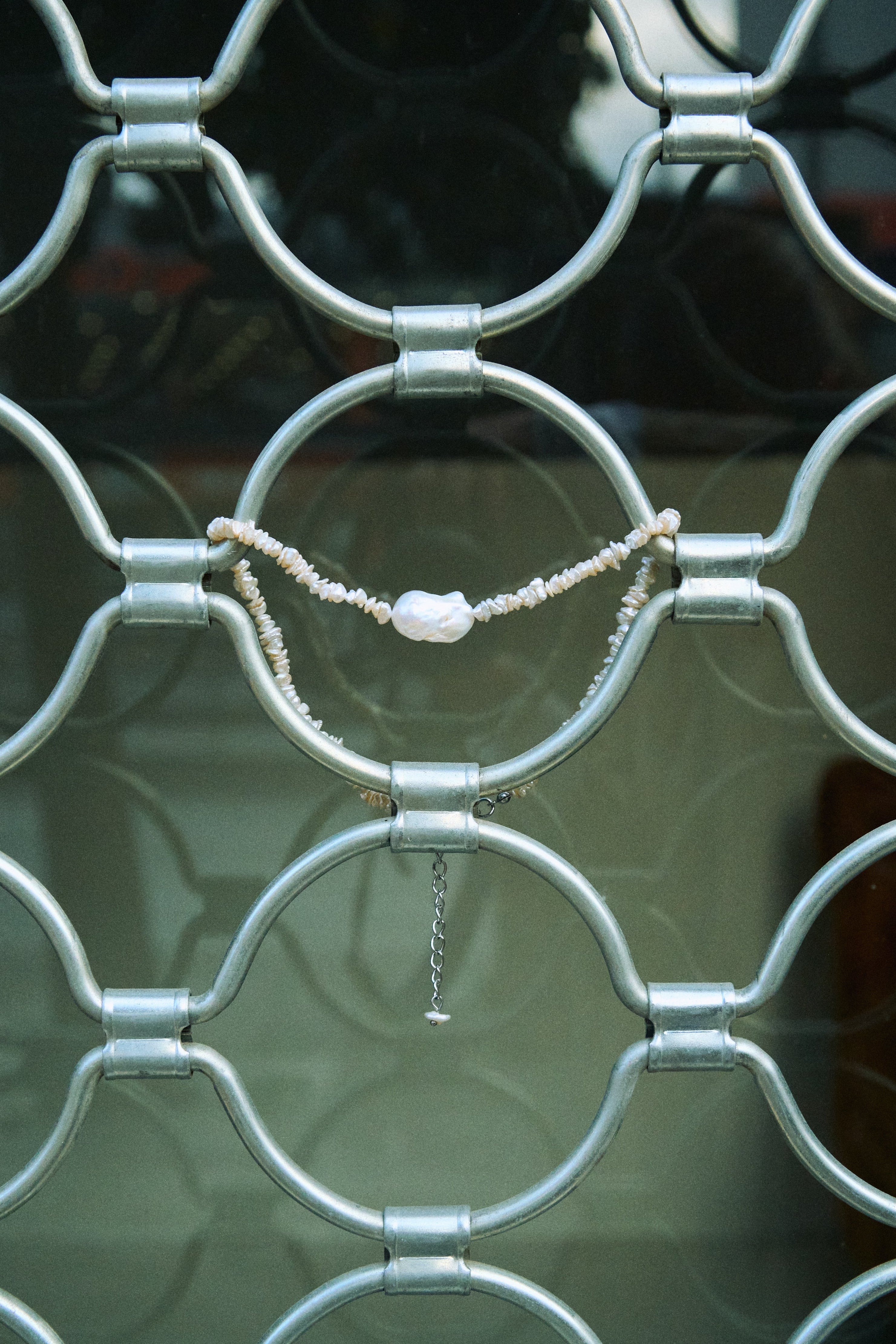 Baroque keshi pearl necklace made from white freshwater keshi pearls with a central natural baroque pearl.