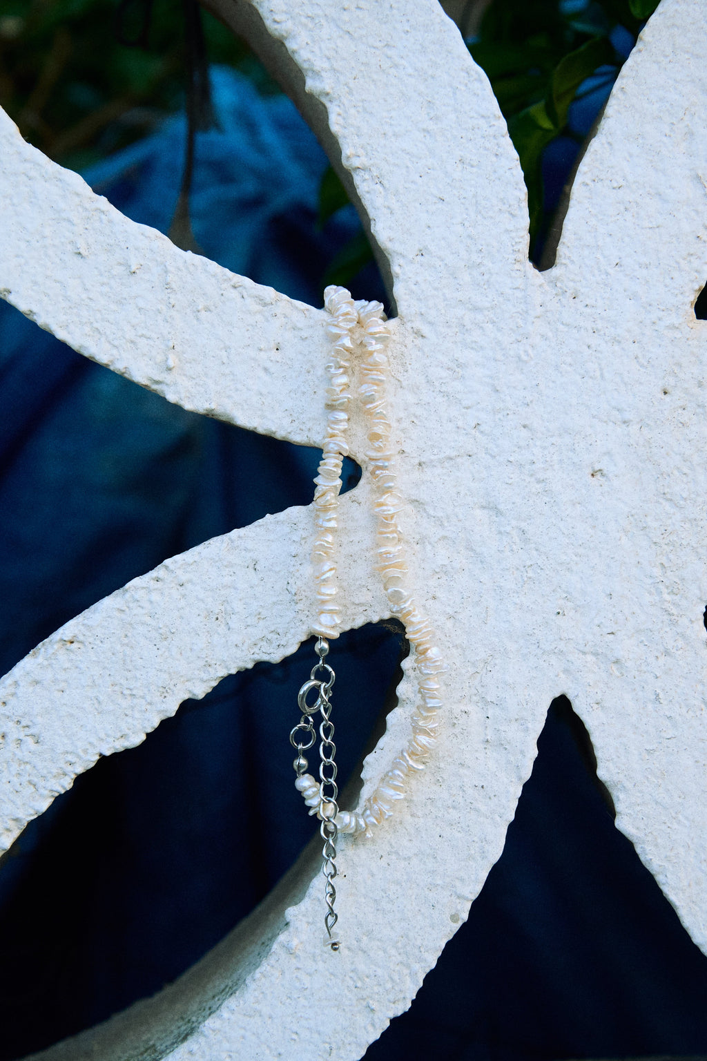 Close-up of a white keshi freshwater pearl necklace with small irregular pearls.