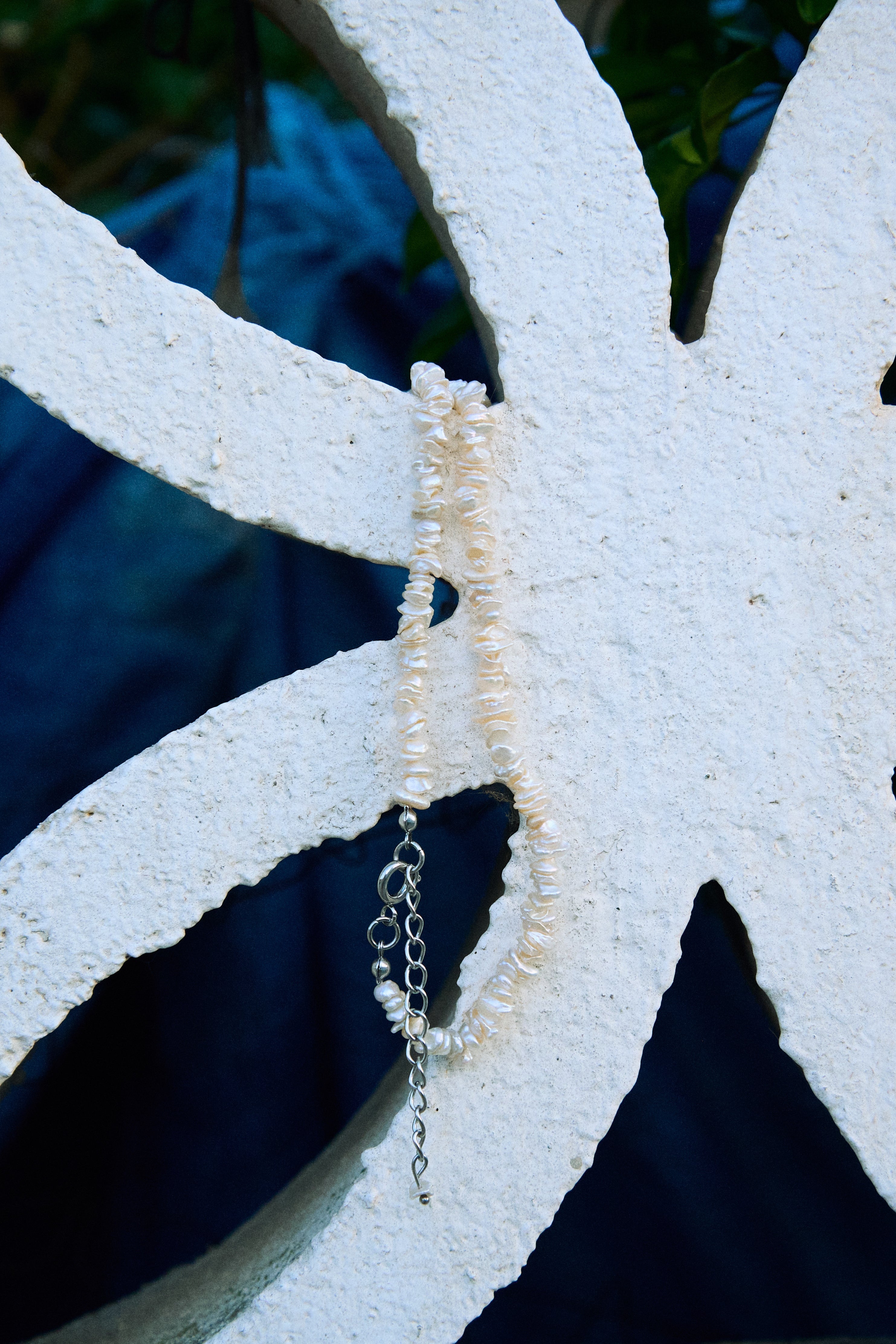 Close-up of a white keshi freshwater pearl necklace with small irregular pearls.